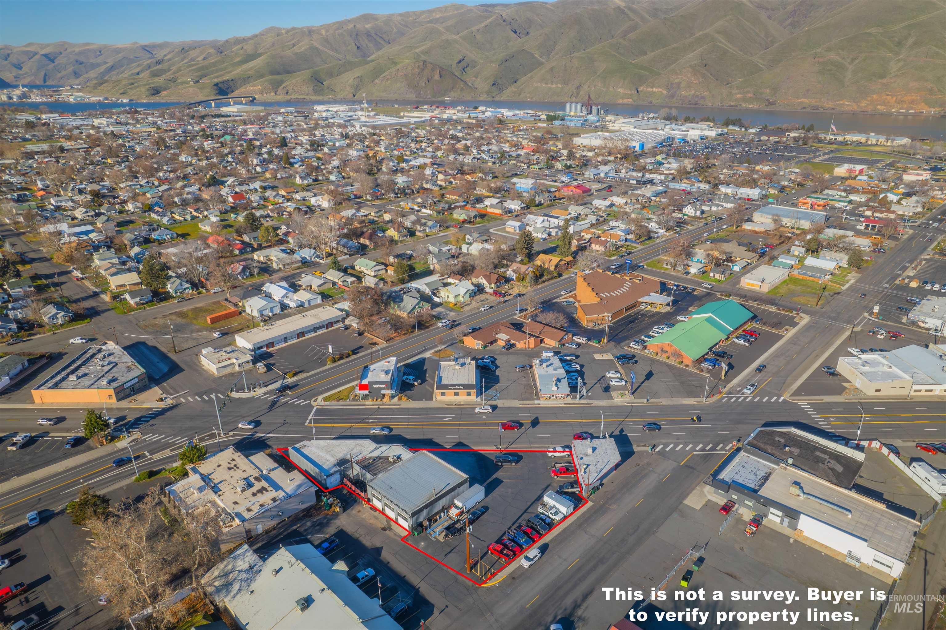 Aerial overview of property's location featuring mountains and an industrial area