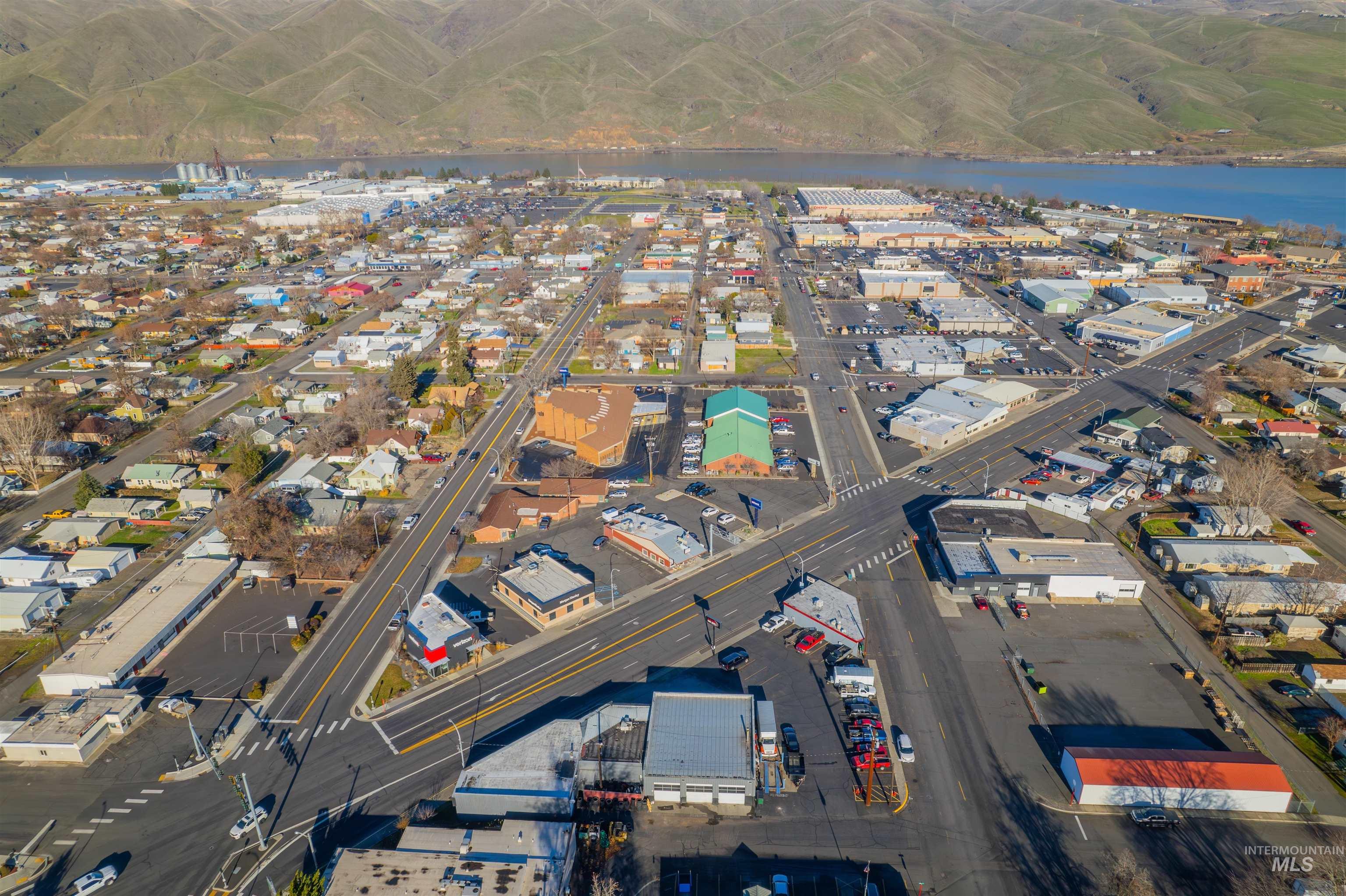 Aerial view of property's location with a nearby body of water and an industrial area