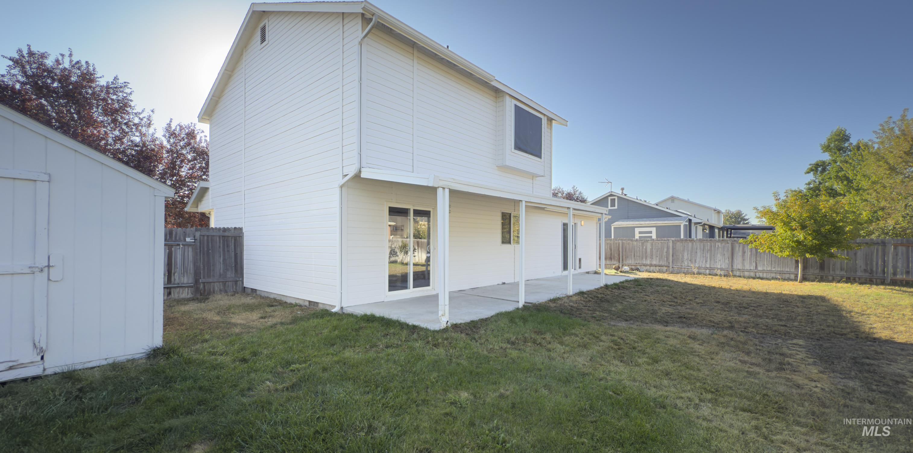 Rear view of property with a patio and a fenced backyard