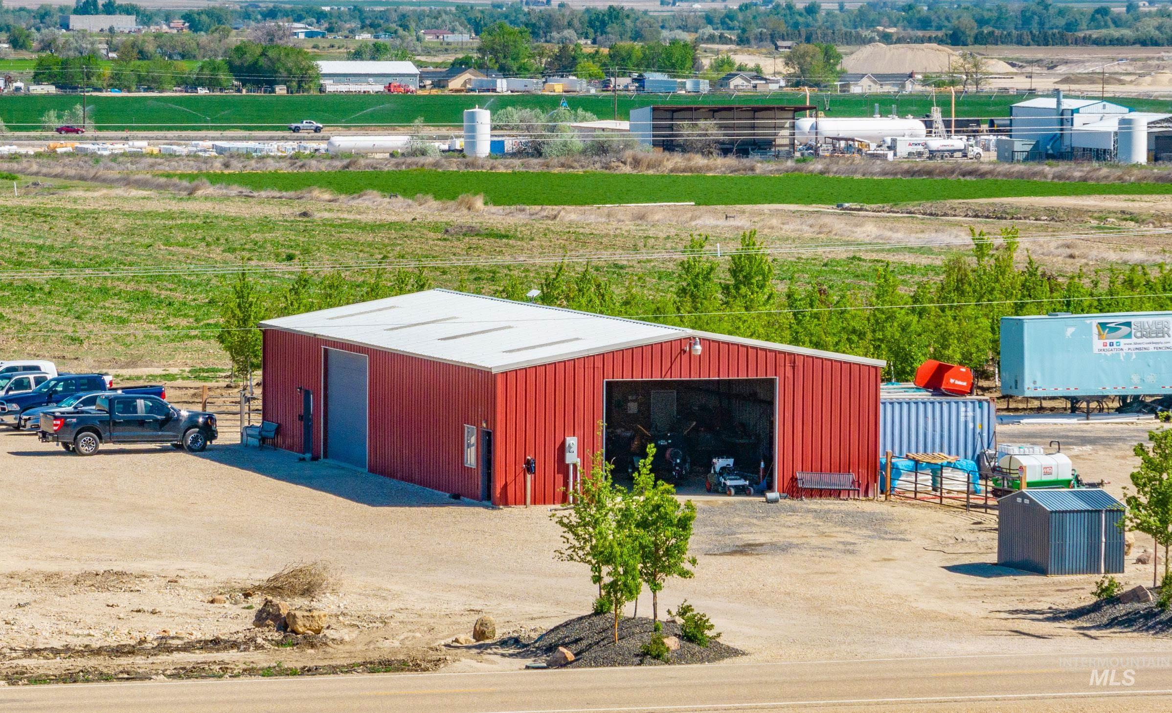 View of pole building featuring a view of countryside and dirt driveway