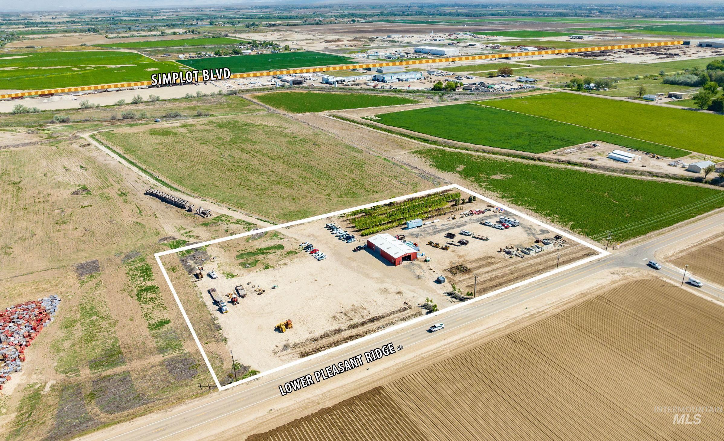 Overview of rural landscape featuring property boundaries highlighted and large plots for crops