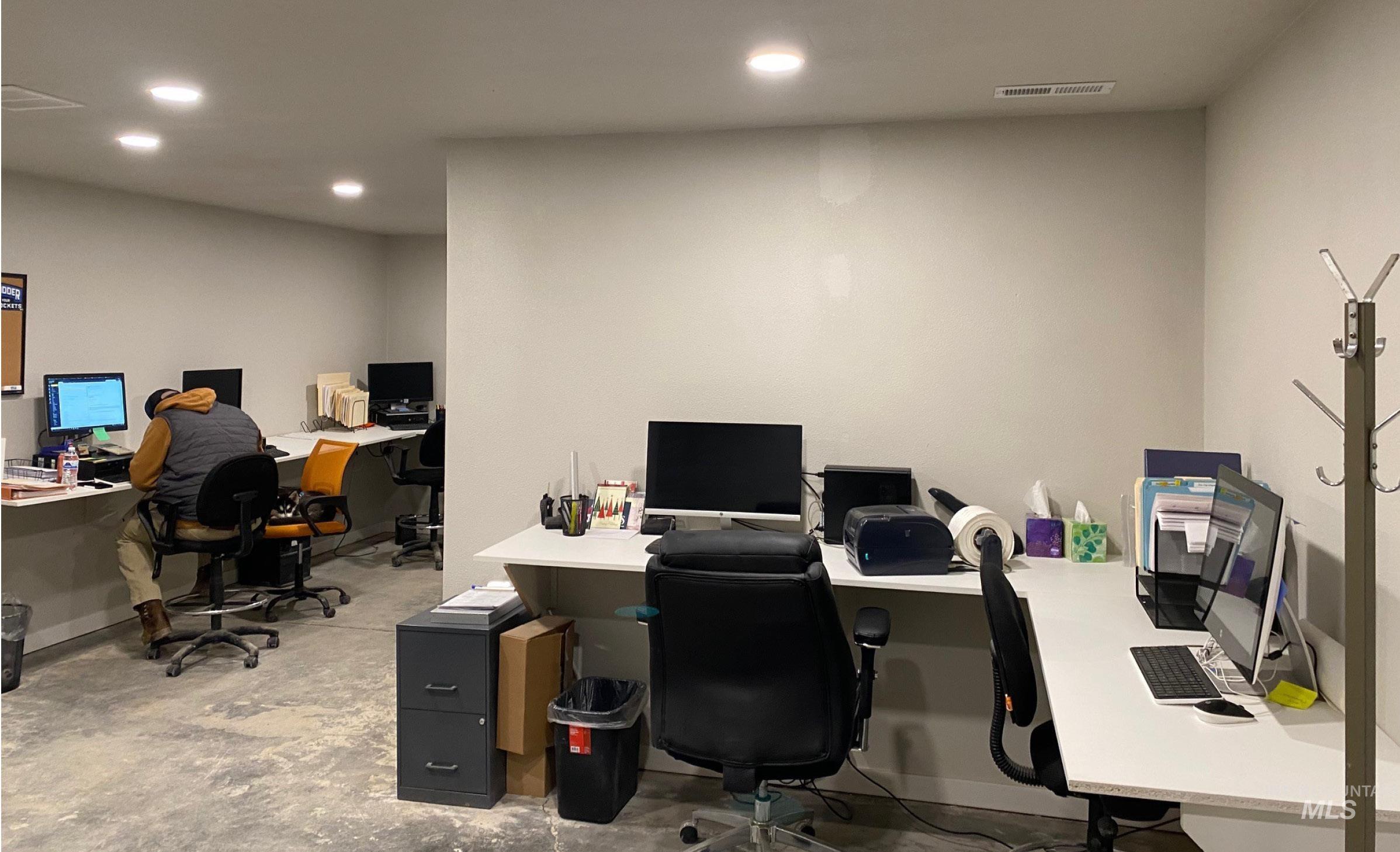Office with concrete floors and recessed lighting