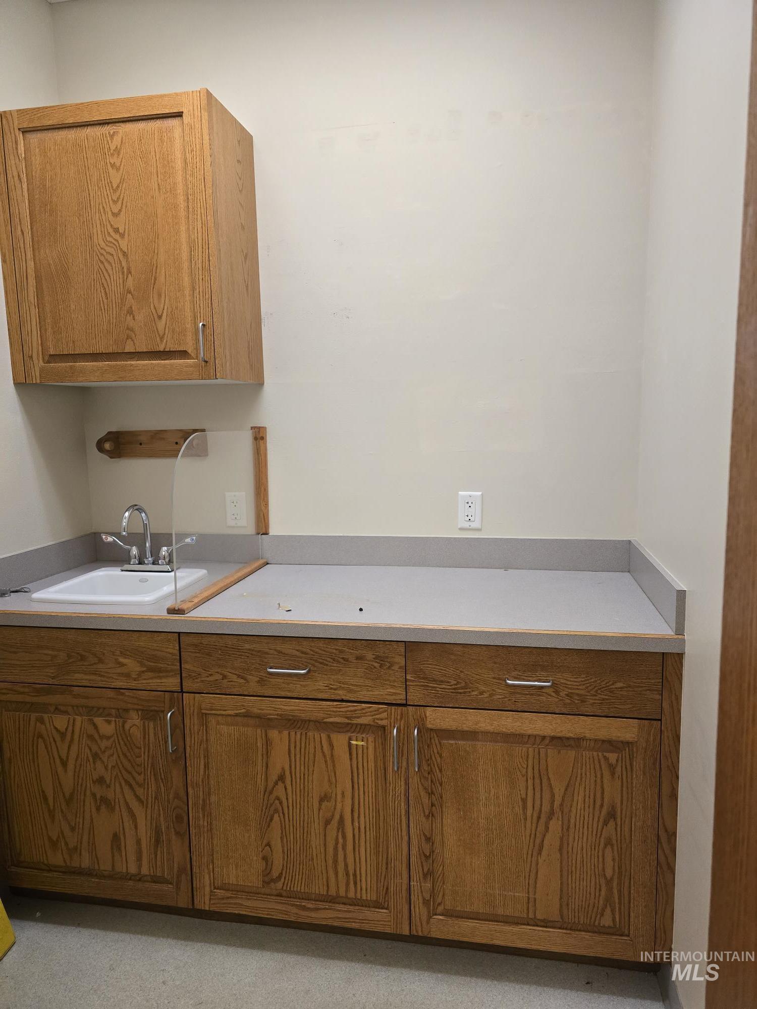 Kitchen with brown cabinets and a sink