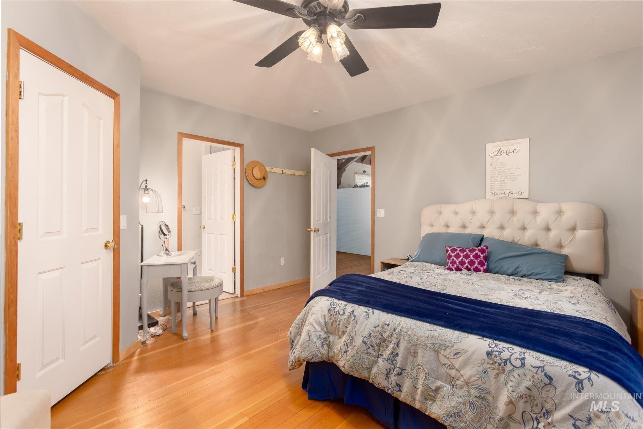 Bedroom featuring wood finished floors and ceiling fan