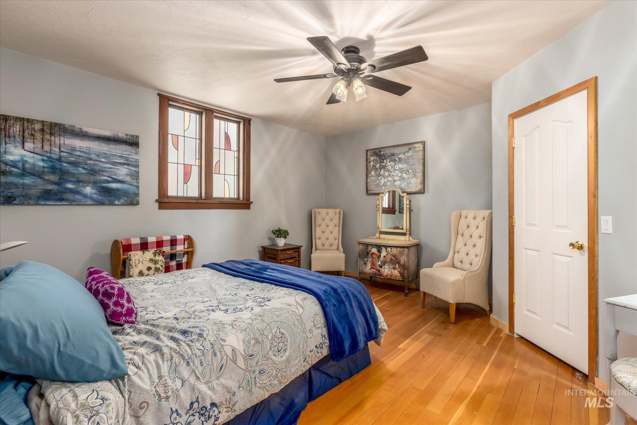 Bedroom with hardwood / wood-style flooring and a ceiling fan