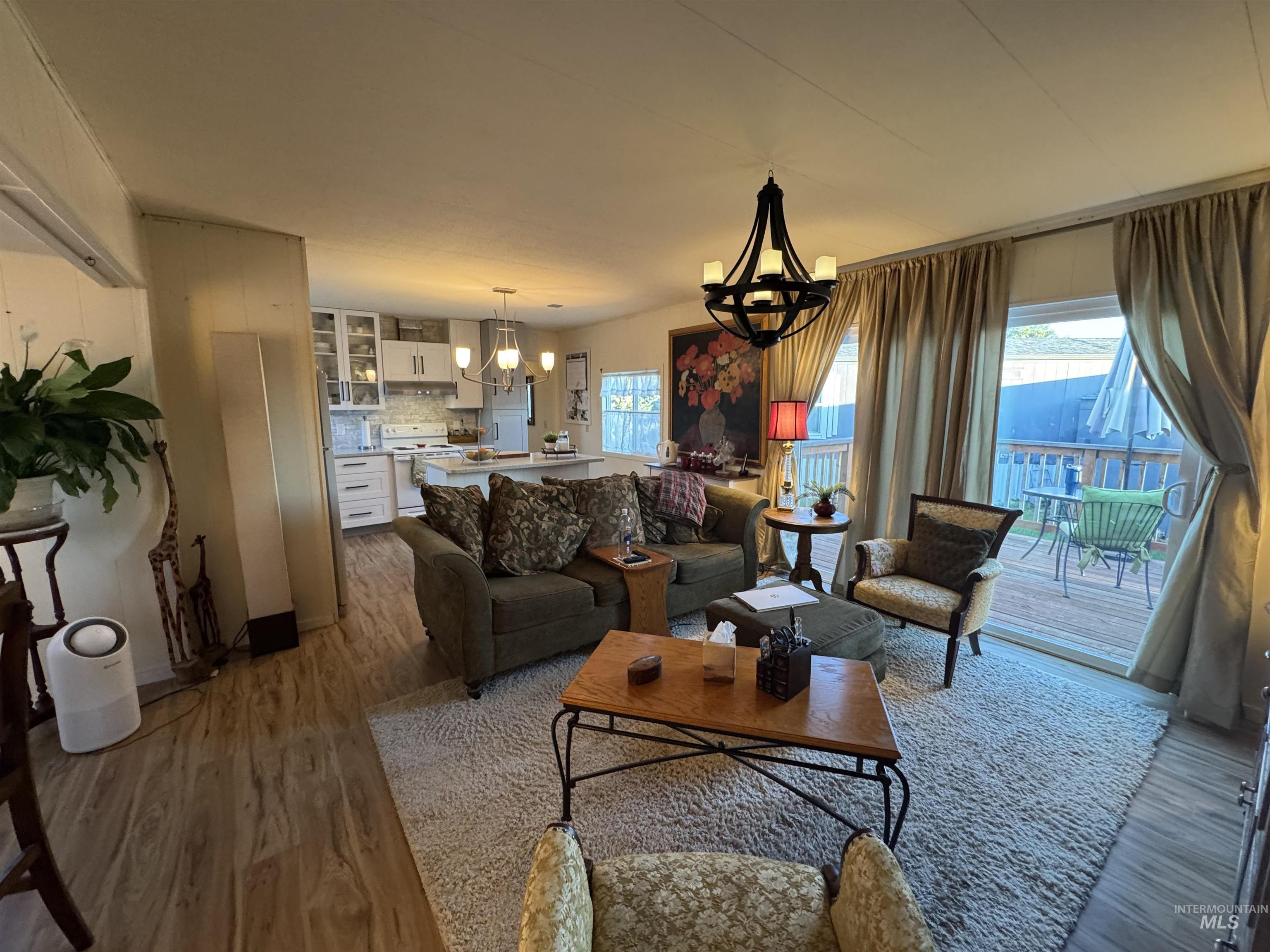 Living room featuring a chandelier and wood finished floors