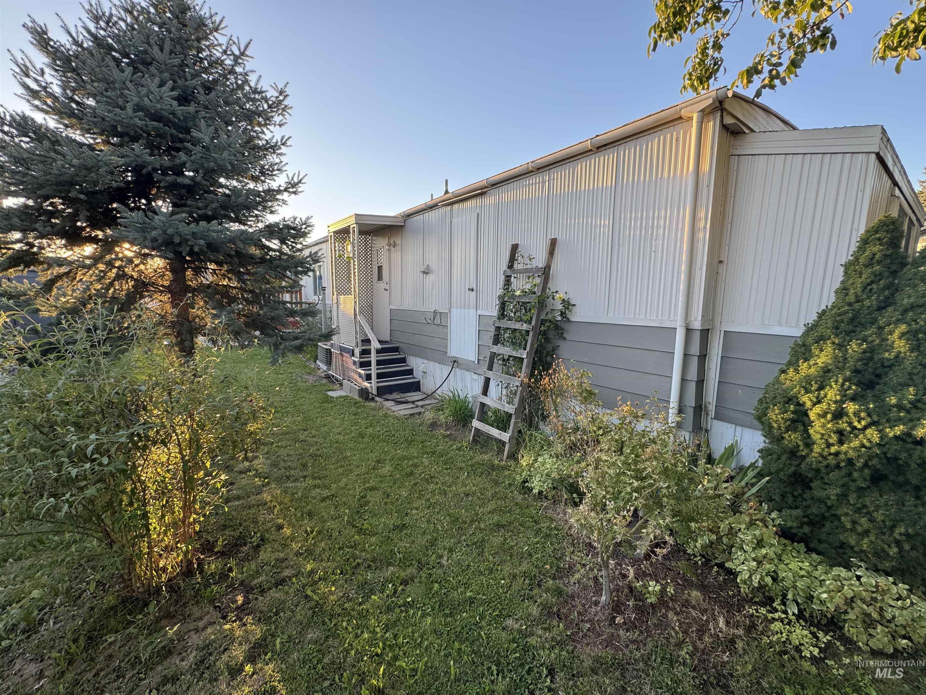 View of side of property with a yard