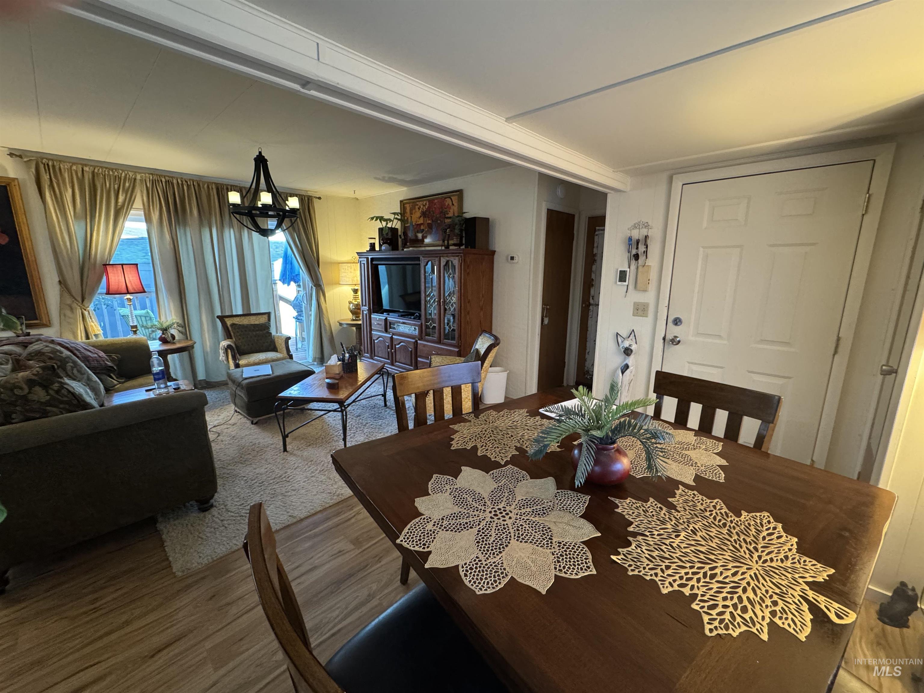 Dining space featuring a chandelier and wood finished floors