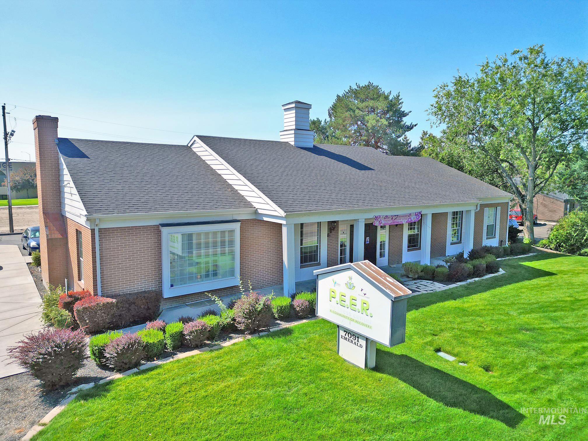 Single story home with brick siding, a chimney, a front lawn, and roof with shingles