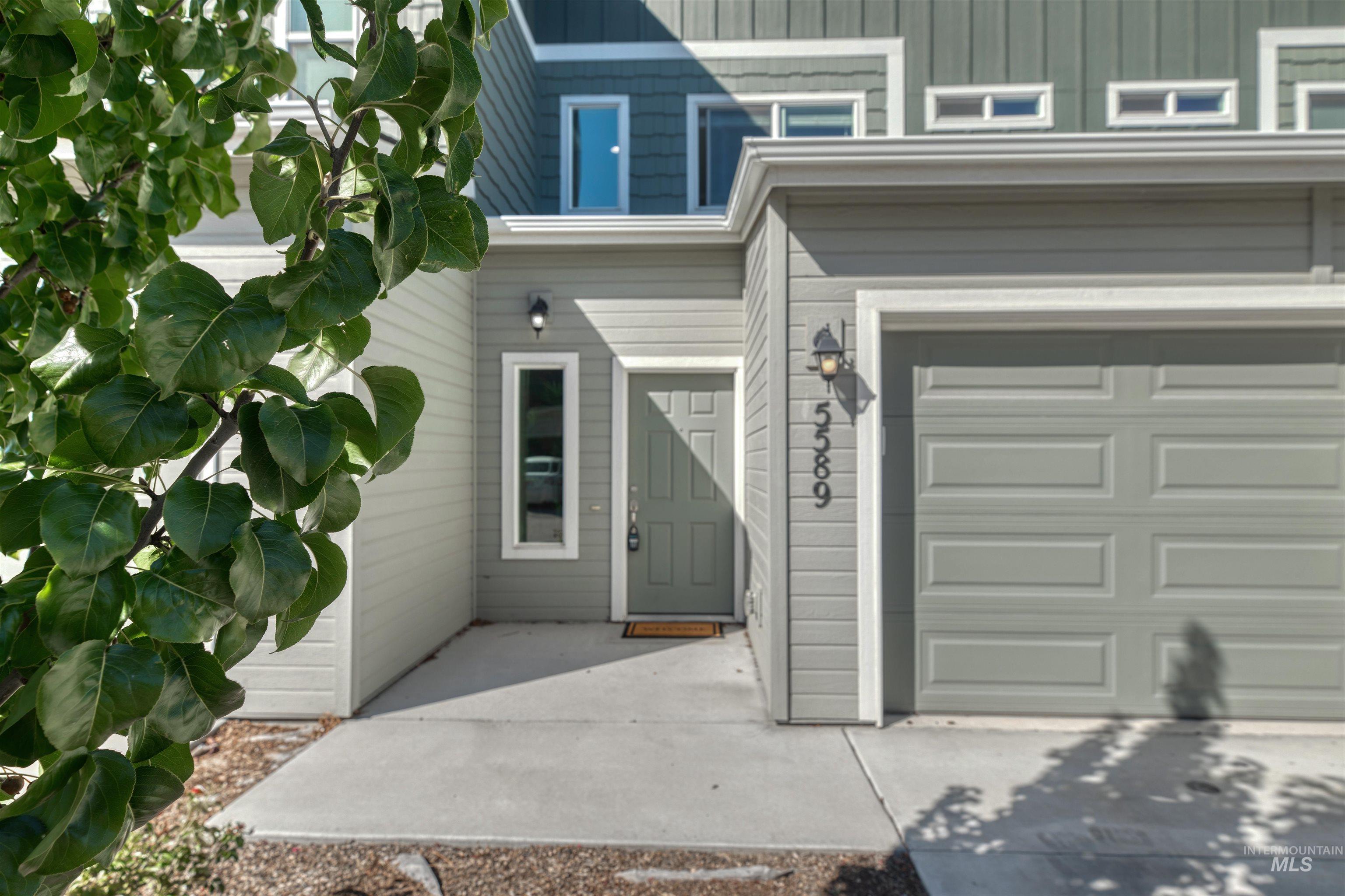 View of exterior entry featuring a garage
