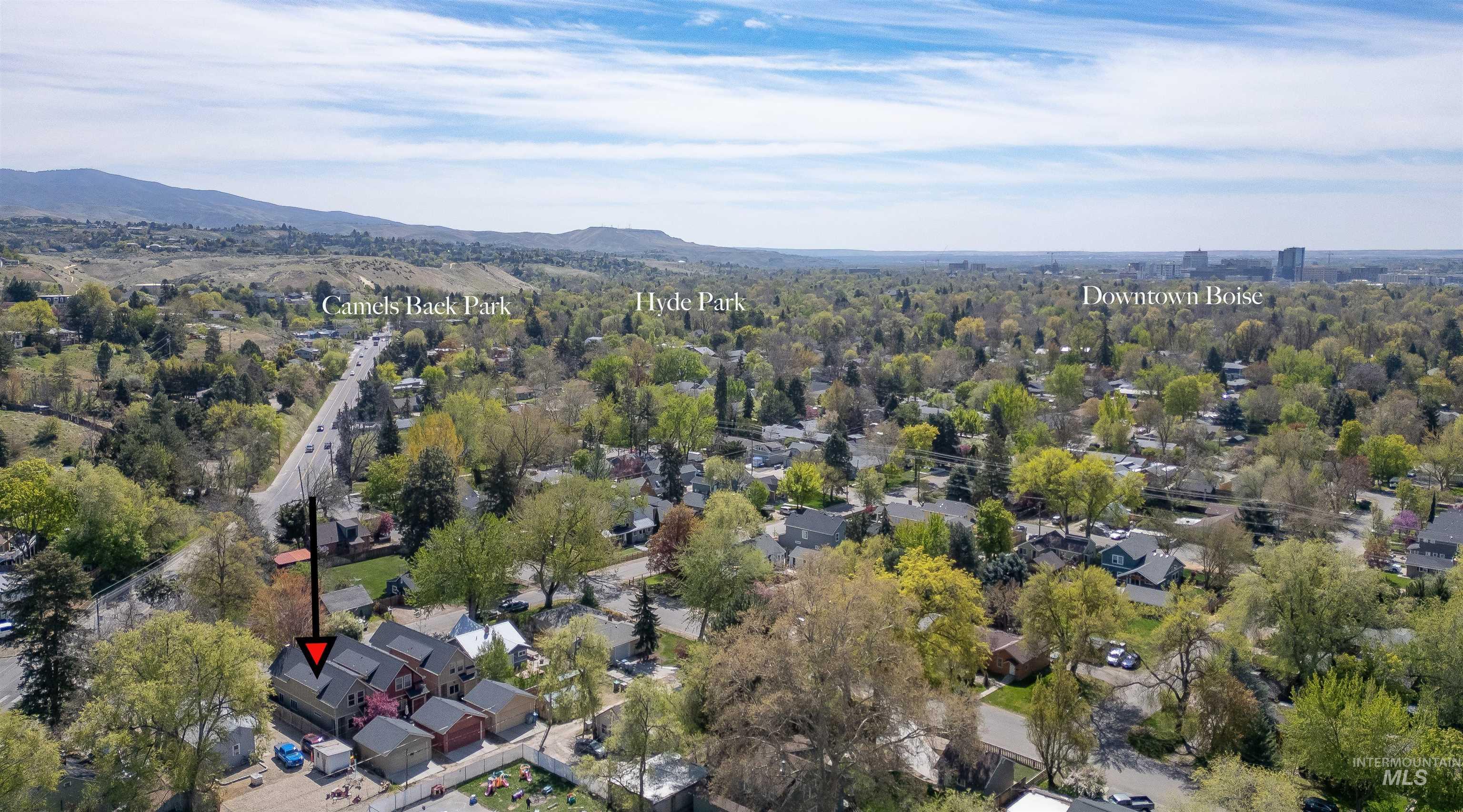 Aerial view of property's location with a mountainous background