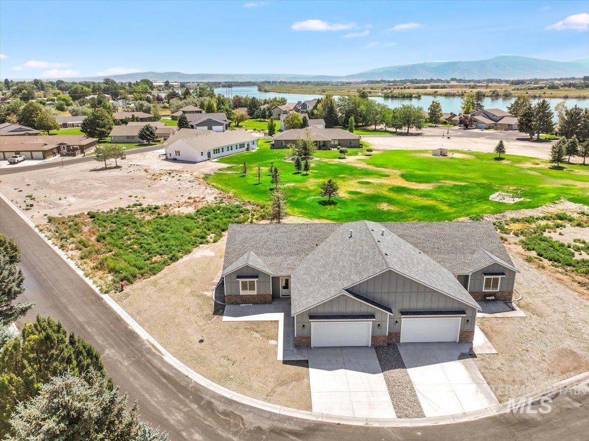 Aerial view of residential area featuring a water and mountain view