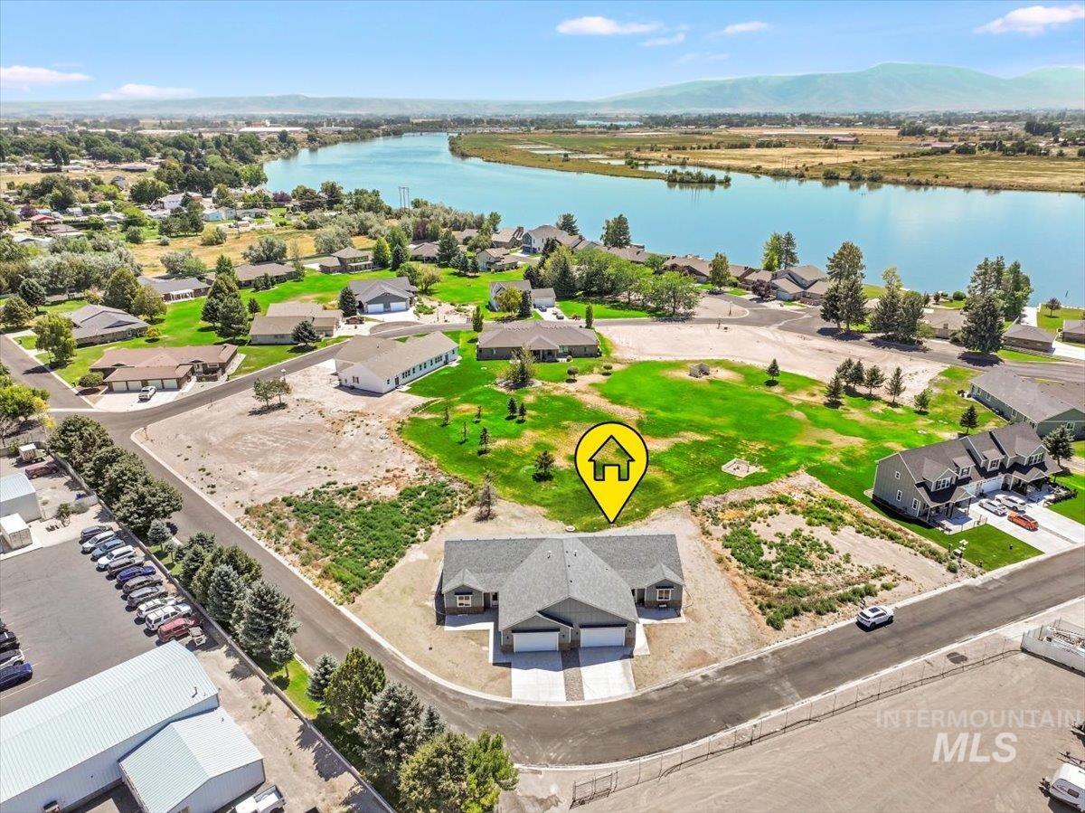 Aerial perspective of suburban area with a water and mountain view