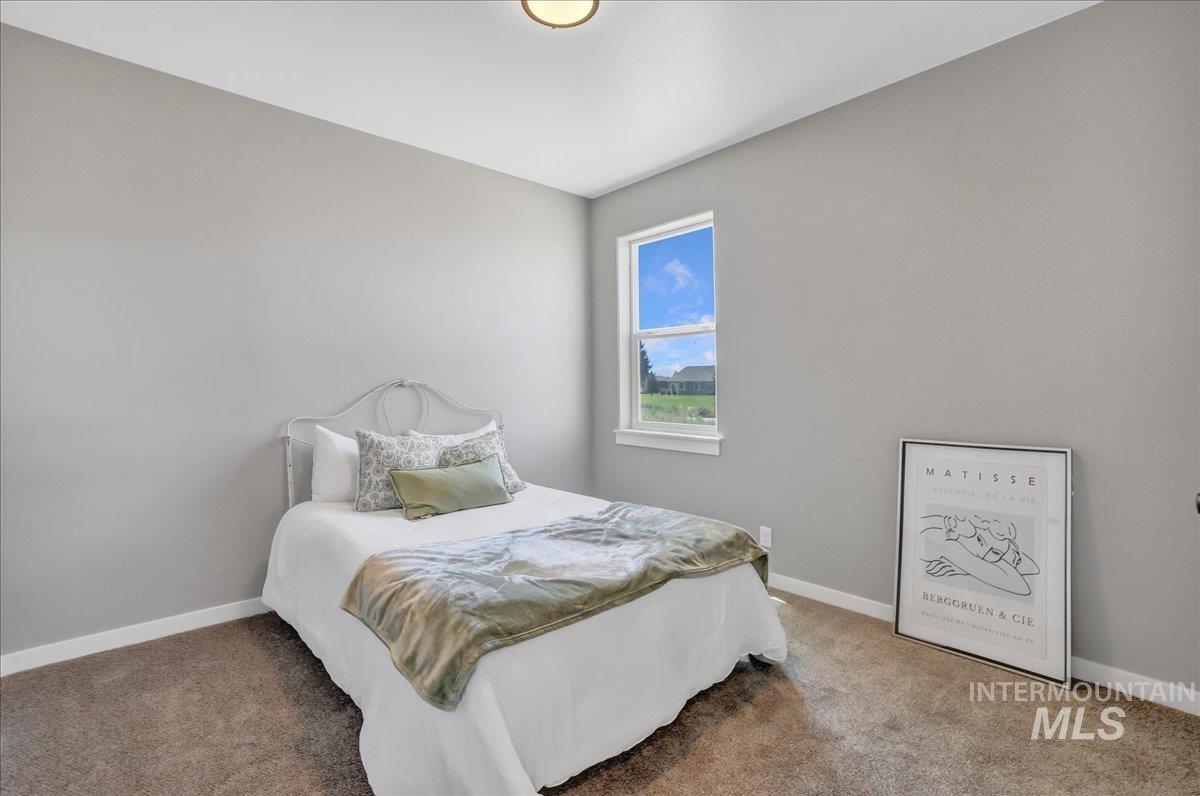 Carpeted bedroom featuring baseboards