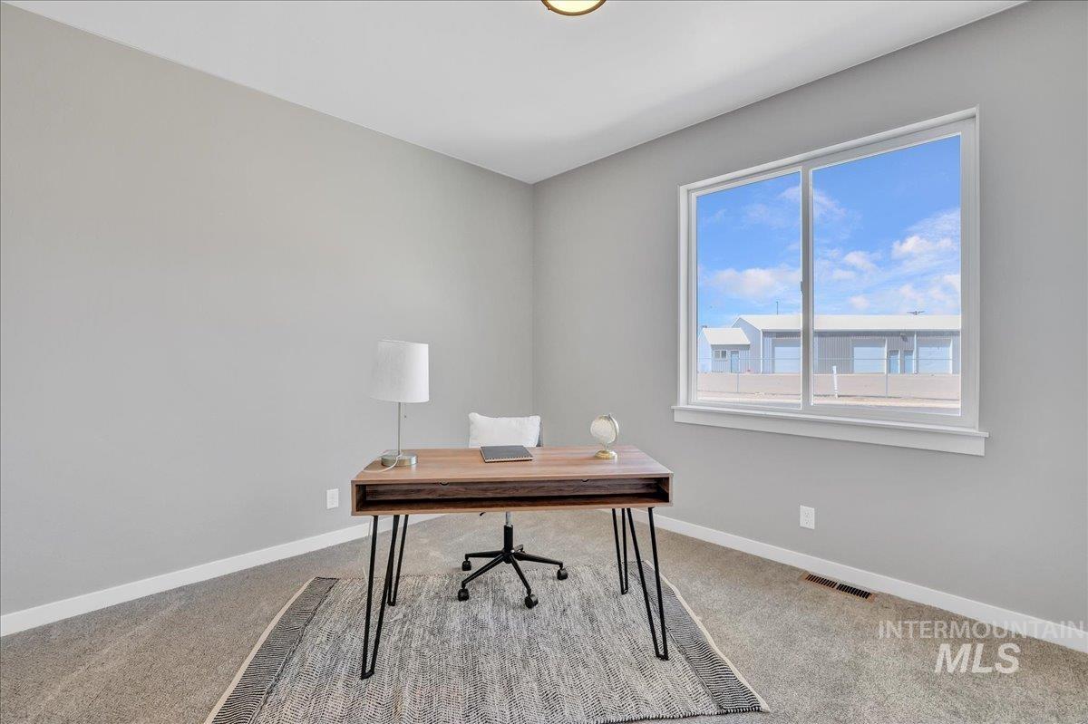 Office area with light carpet and baseboards
