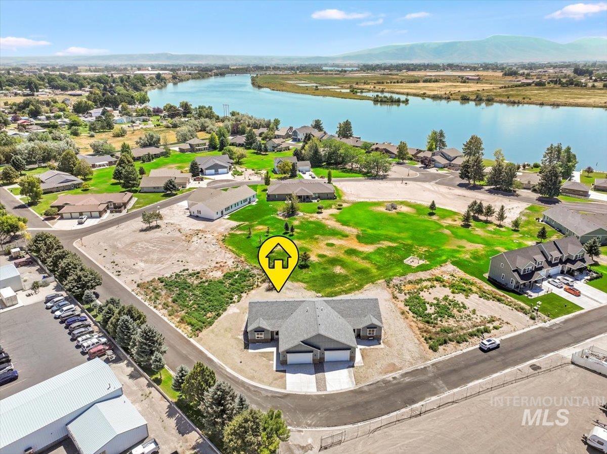 Aerial perspective of suburban area with a water and mountain view