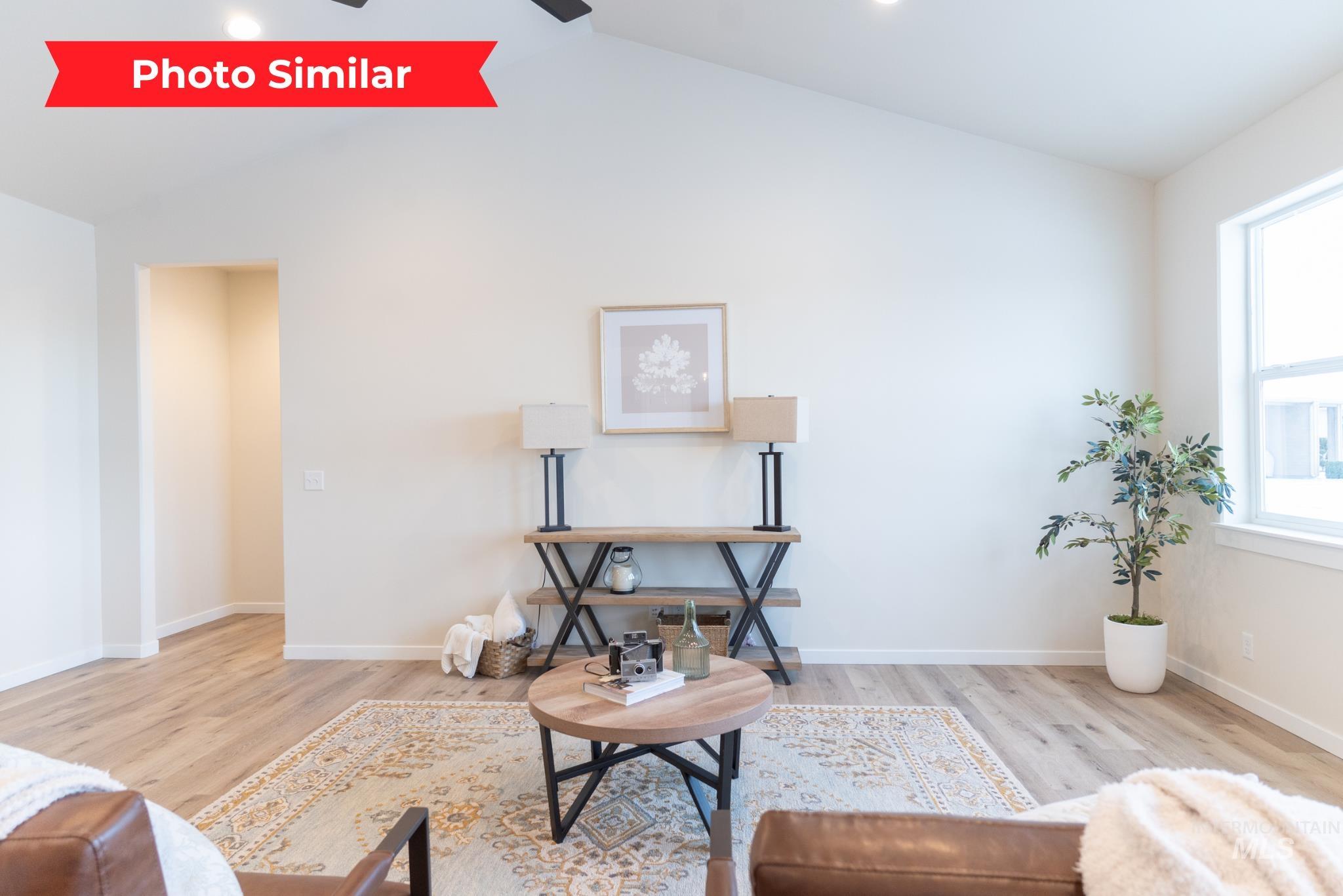 Sitting room featuring light wood-style flooring and ceiling fan
