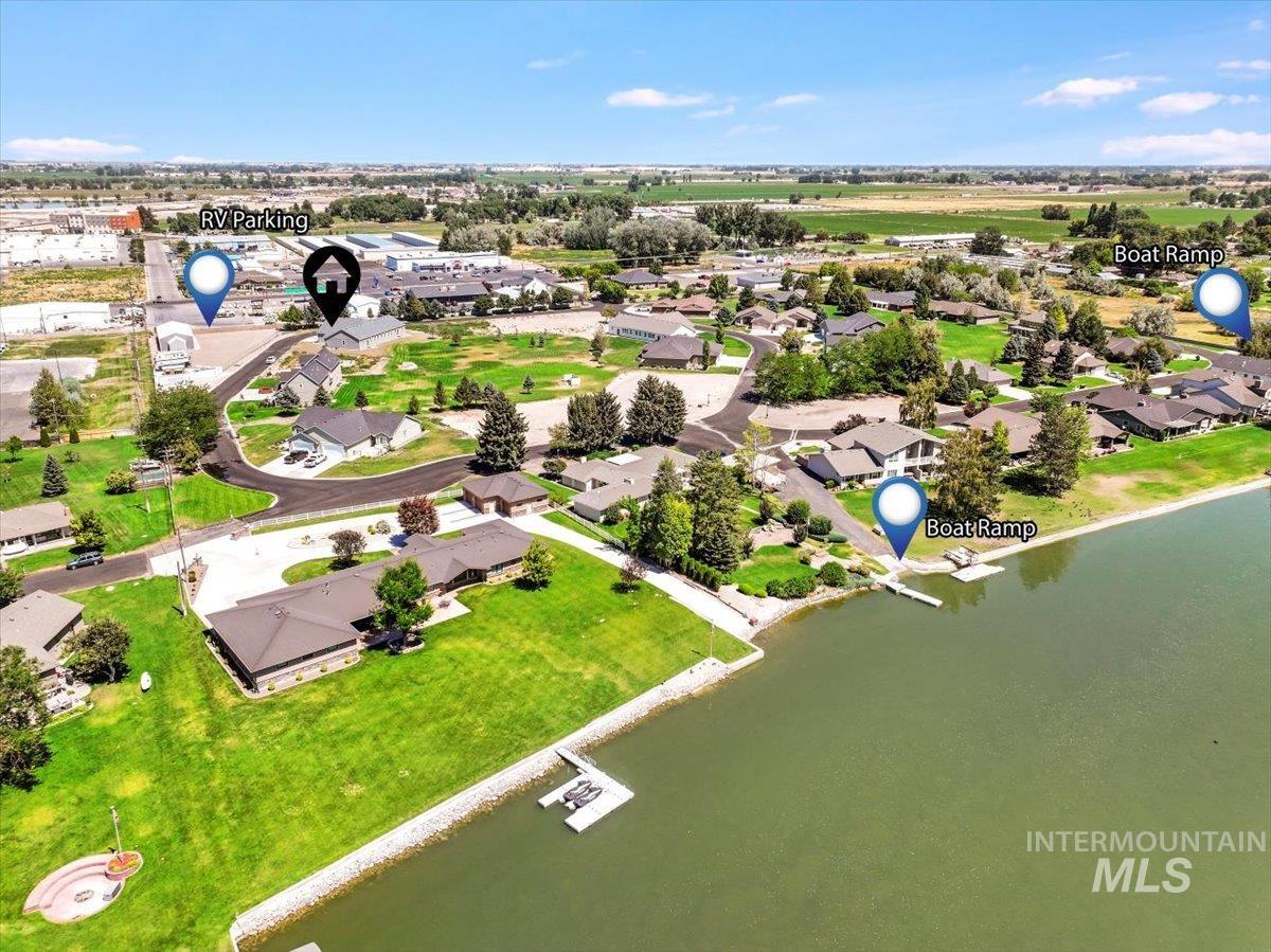 Aerial perspective of suburban area featuring a large body of water