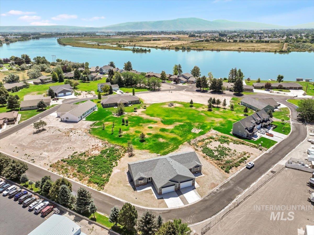 Aerial view of residential area featuring a water and mountain view
