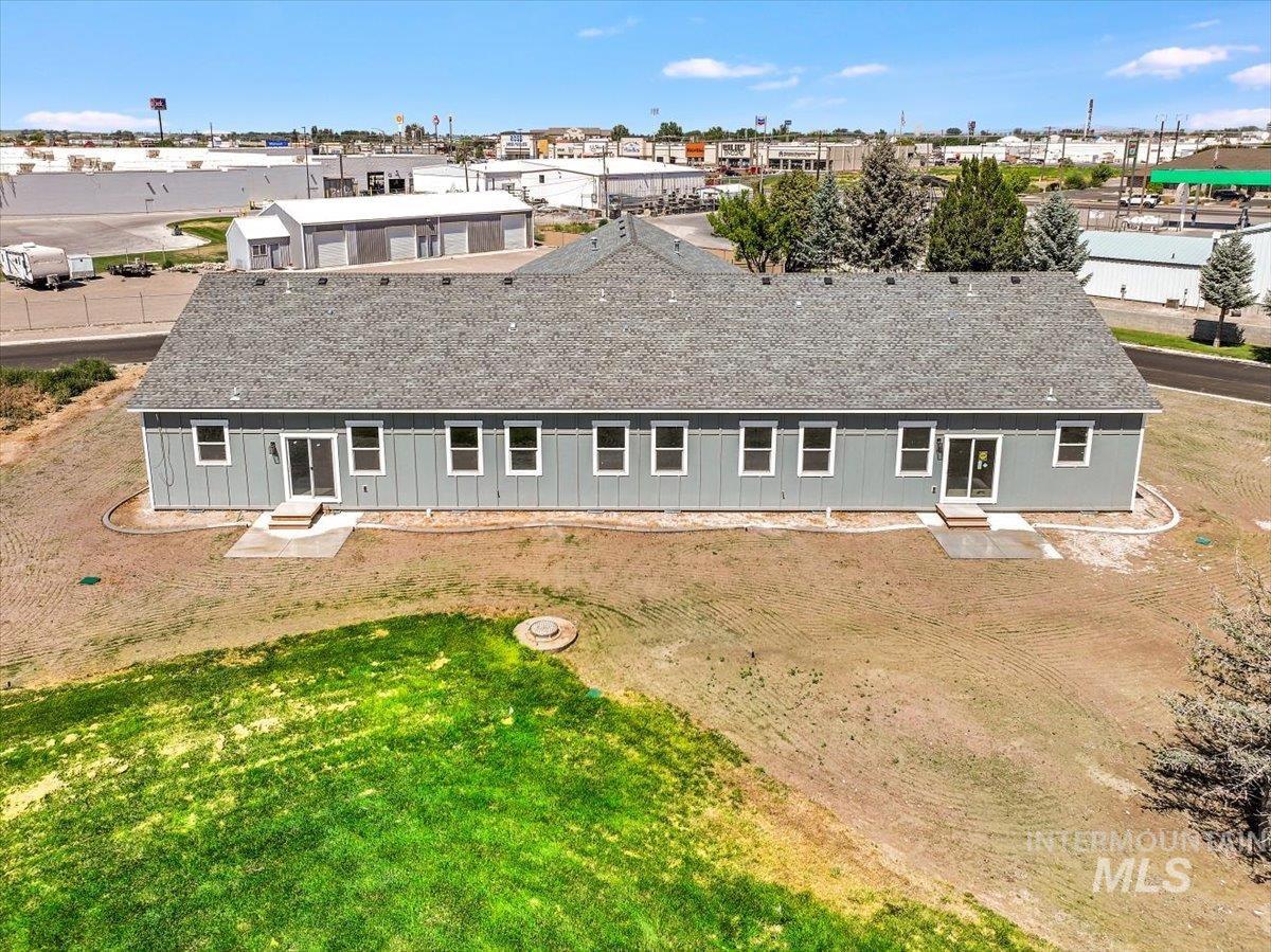 Rear view of property with roof with shingles and entry steps