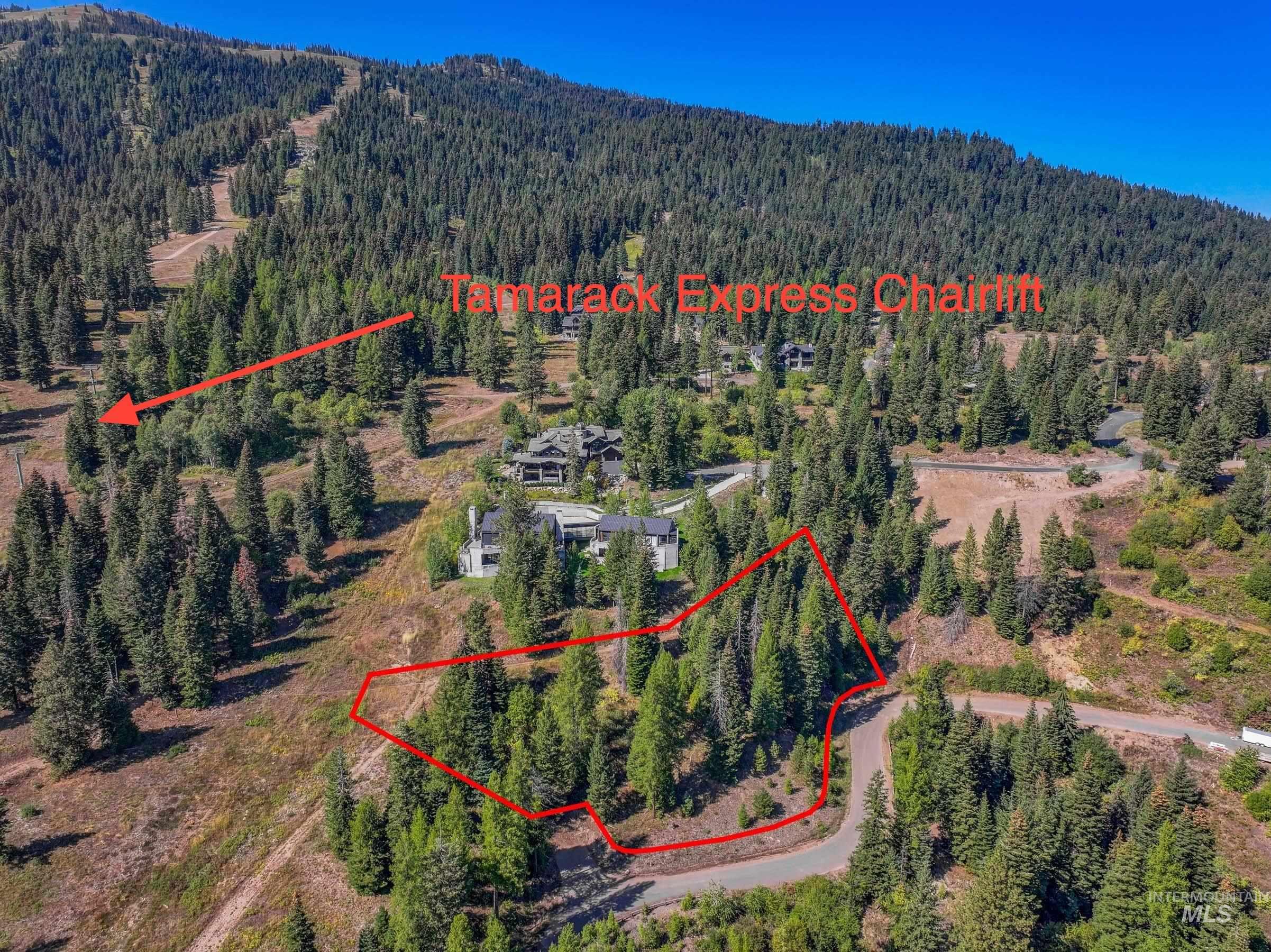 Aerial view of property and surrounding area with property parcel outlined