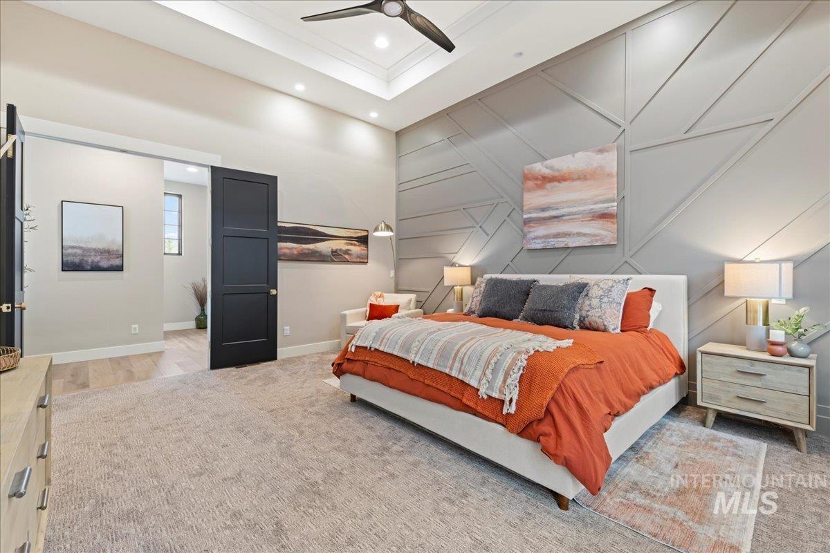 Bedroom featuring a decorative wall, a ceiling fan, a towering ceiling, and recessed lighting
