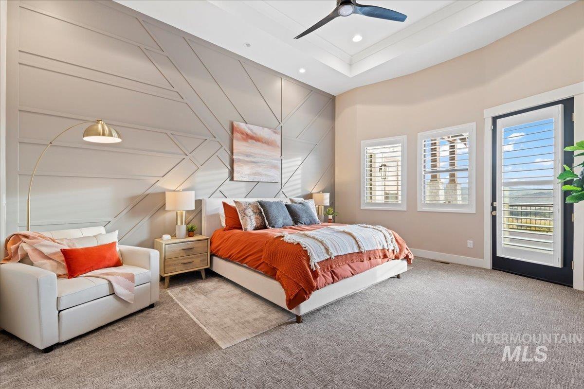 Bedroom featuring an accent wall, access to outside, carpet floors, a decorative wall, and ceiling fan