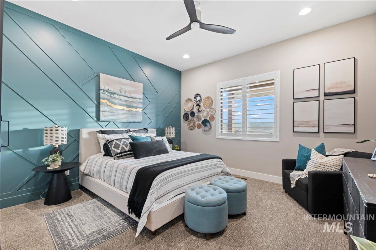 Carpeted bedroom featuring an accent wall, a ceiling fan, and recessed lighting