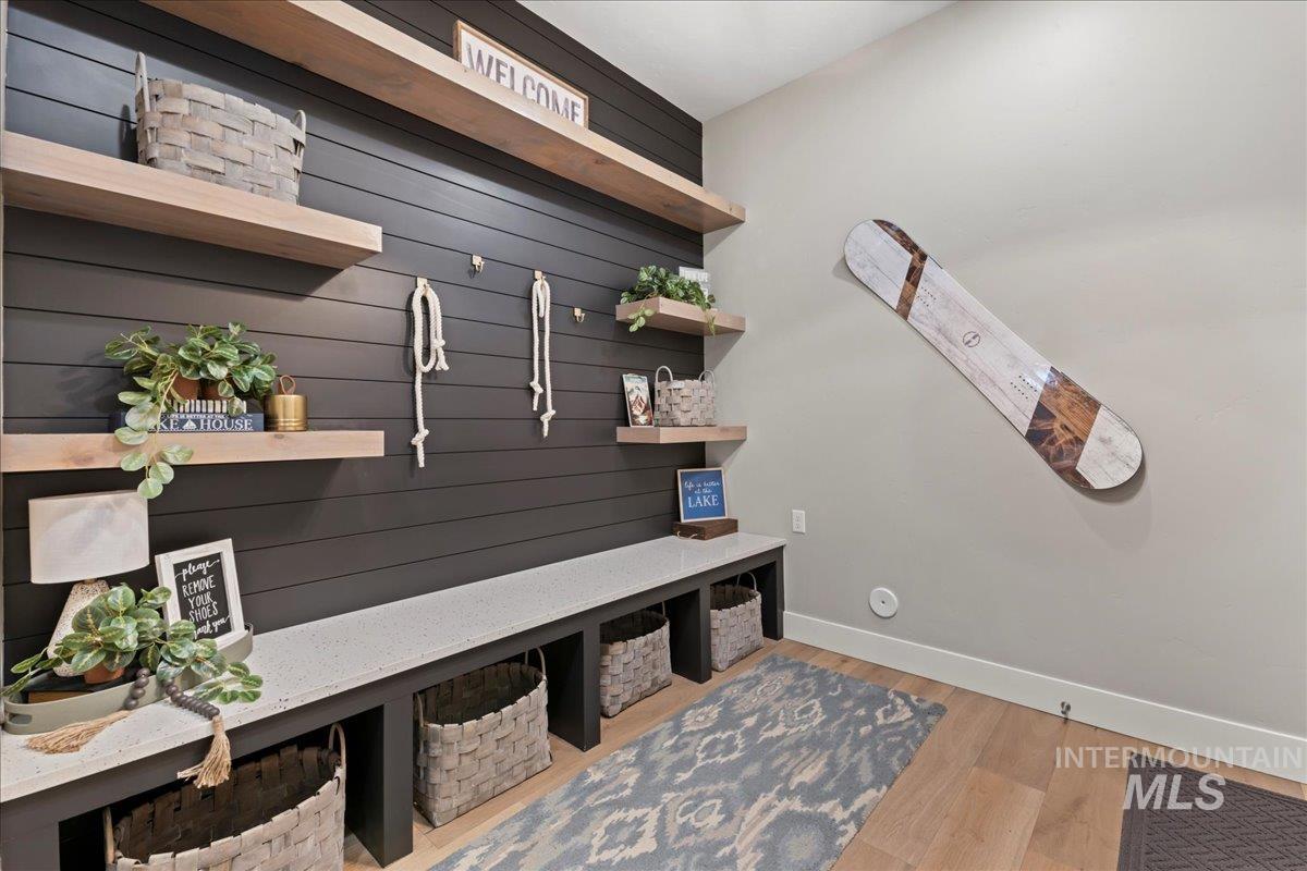 Mudroom featuring light wood finished floors and baseboards