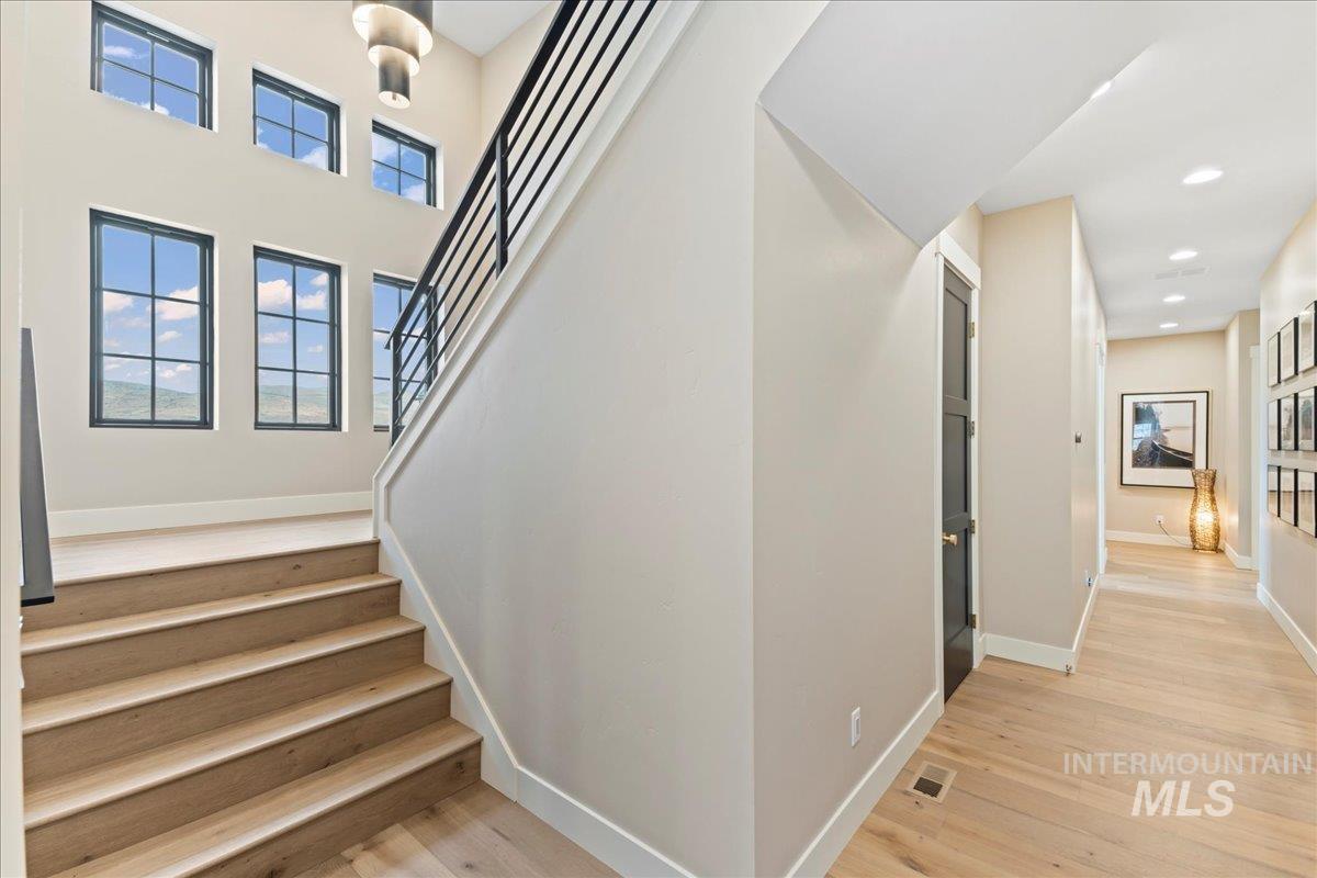 Stairs featuring wood finished floors
