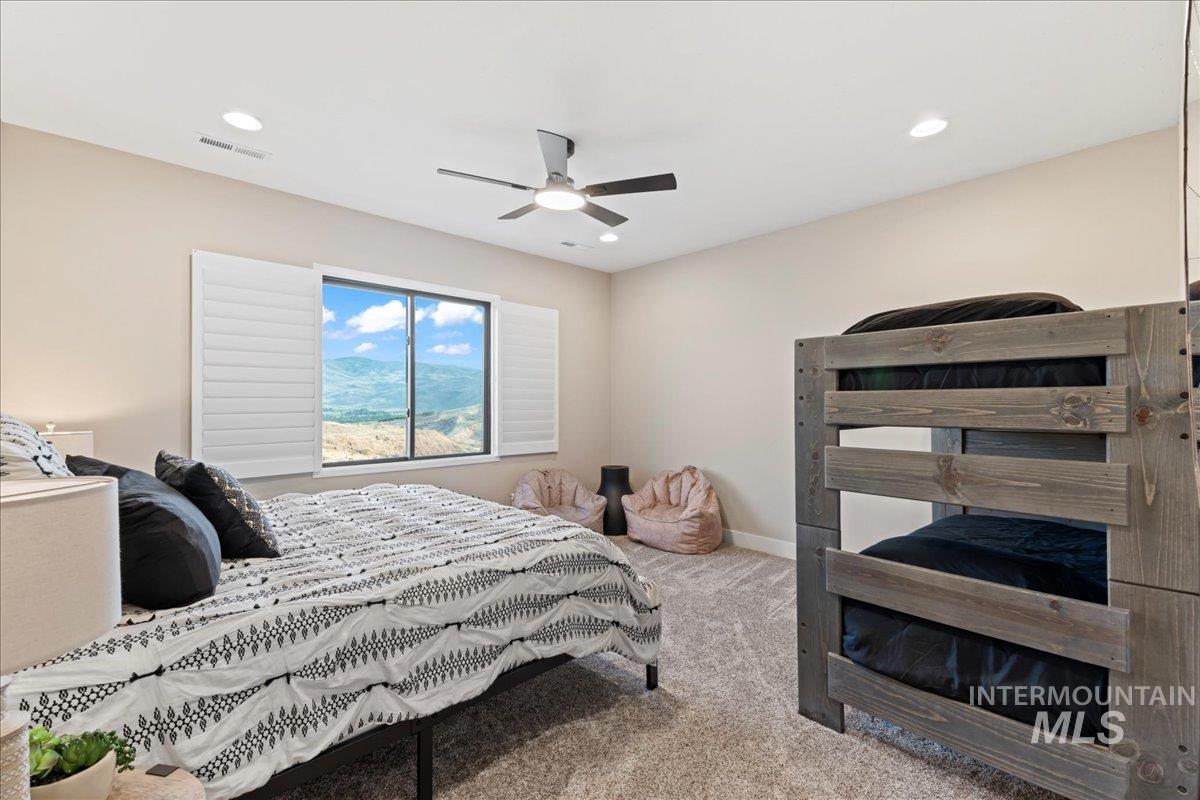 Bedroom with light carpet, recessed lighting, and a ceiling fan