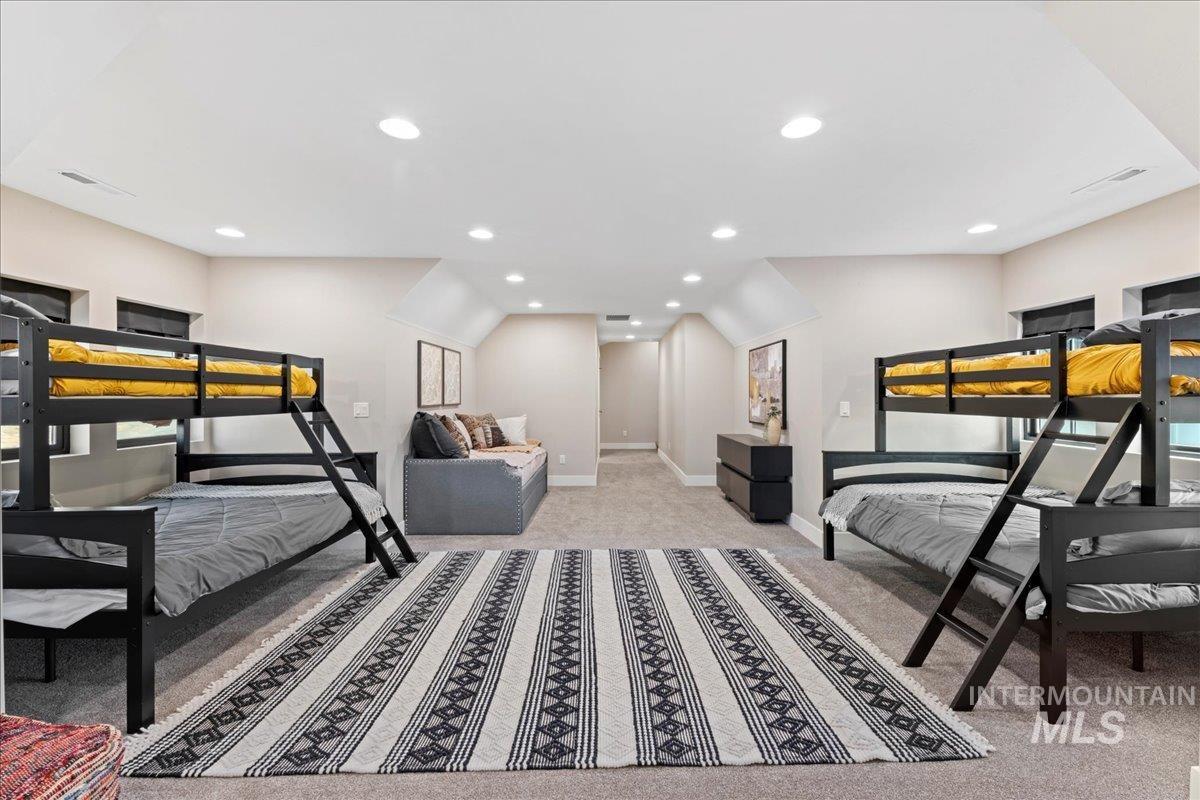 Bedroom with recessed lighting and light colored carpet