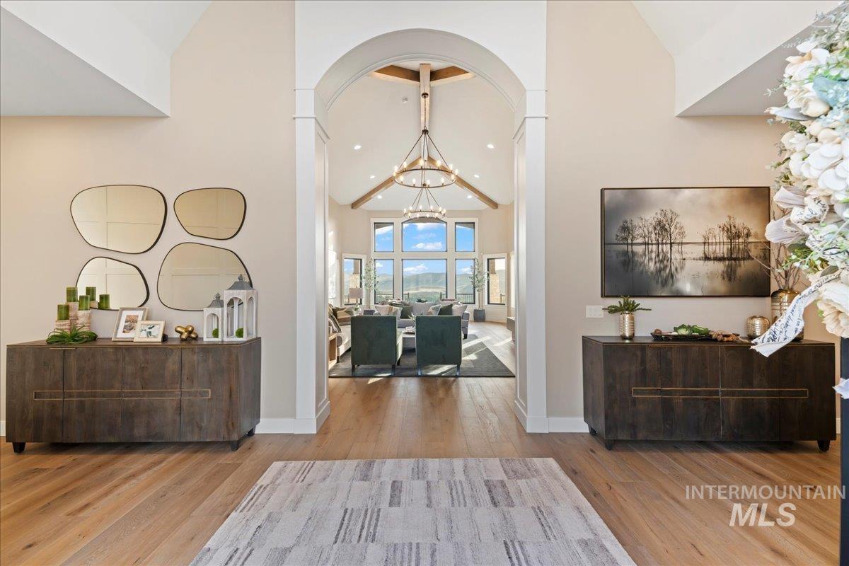 Foyer featuring high vaulted ceiling, a chandelier, recessed lighting, and light wood finished floors