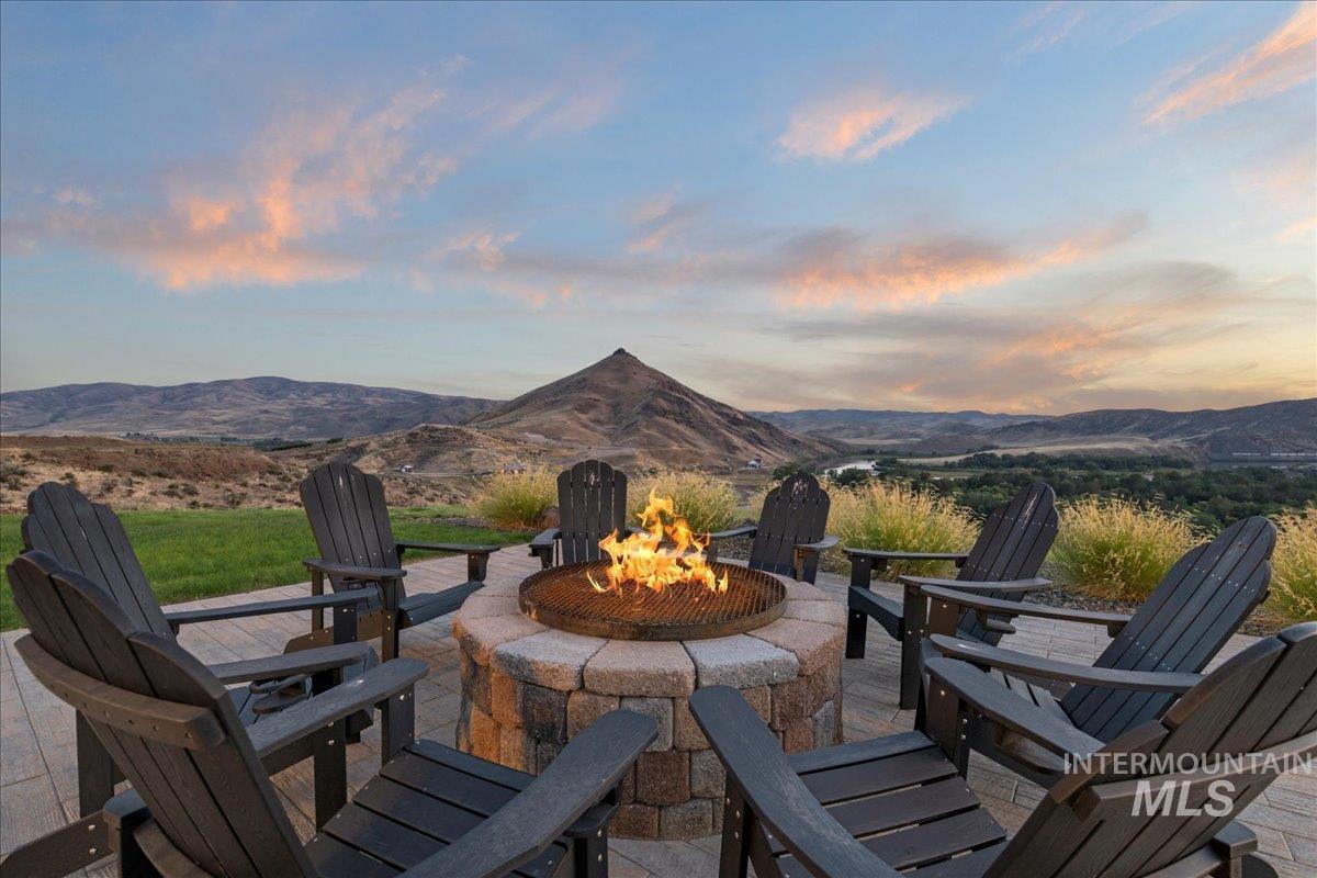 View of patio featuring a fire pit and a mountain view