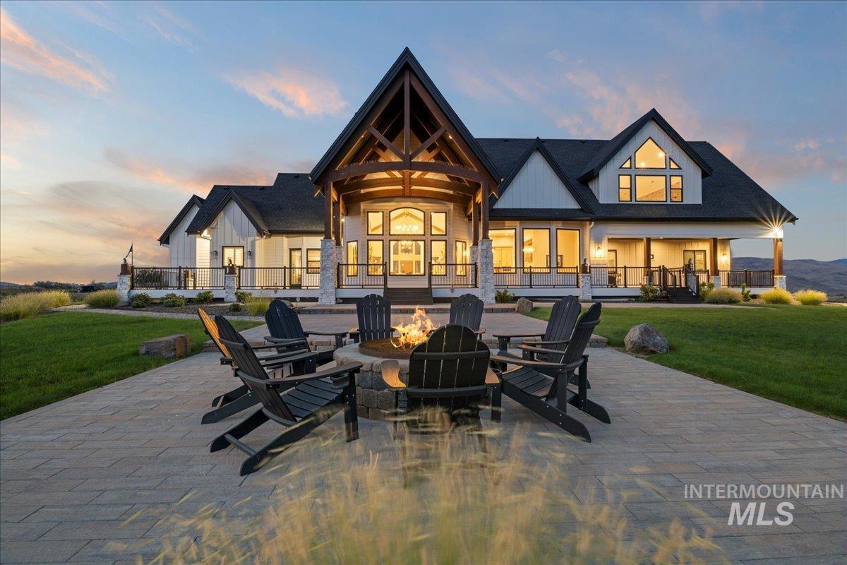 Rear view of house featuring a fire pit, a yard, and a patio area