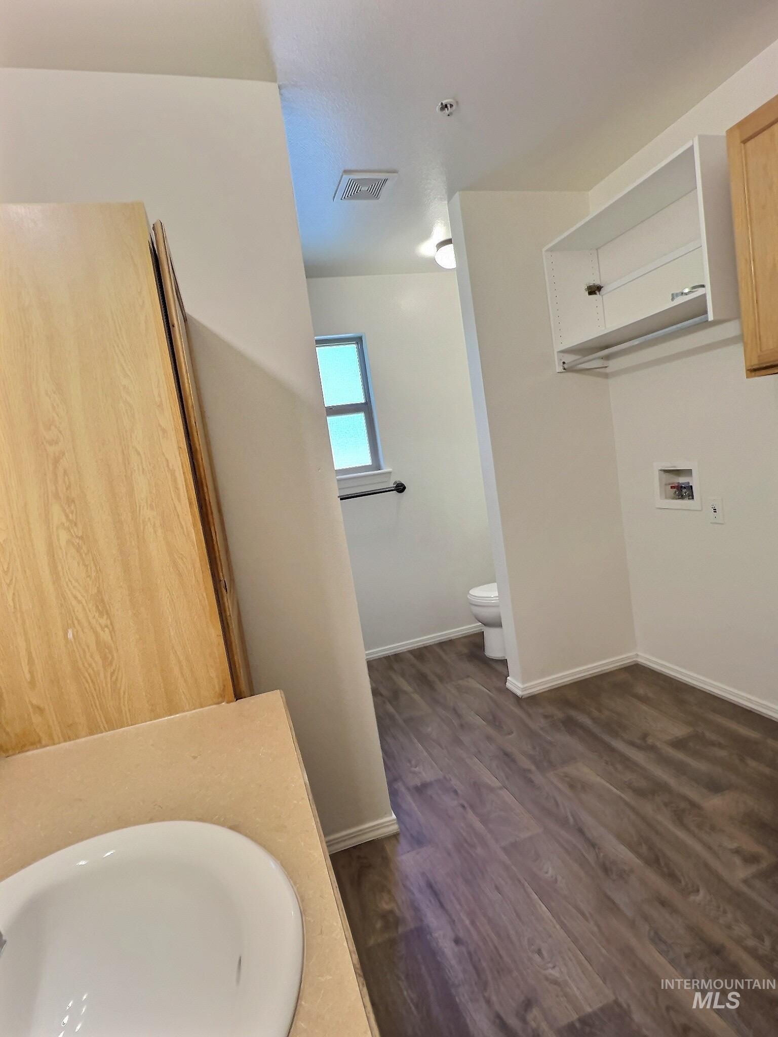 Bathroom featuring dark wood finished floors and vanity
