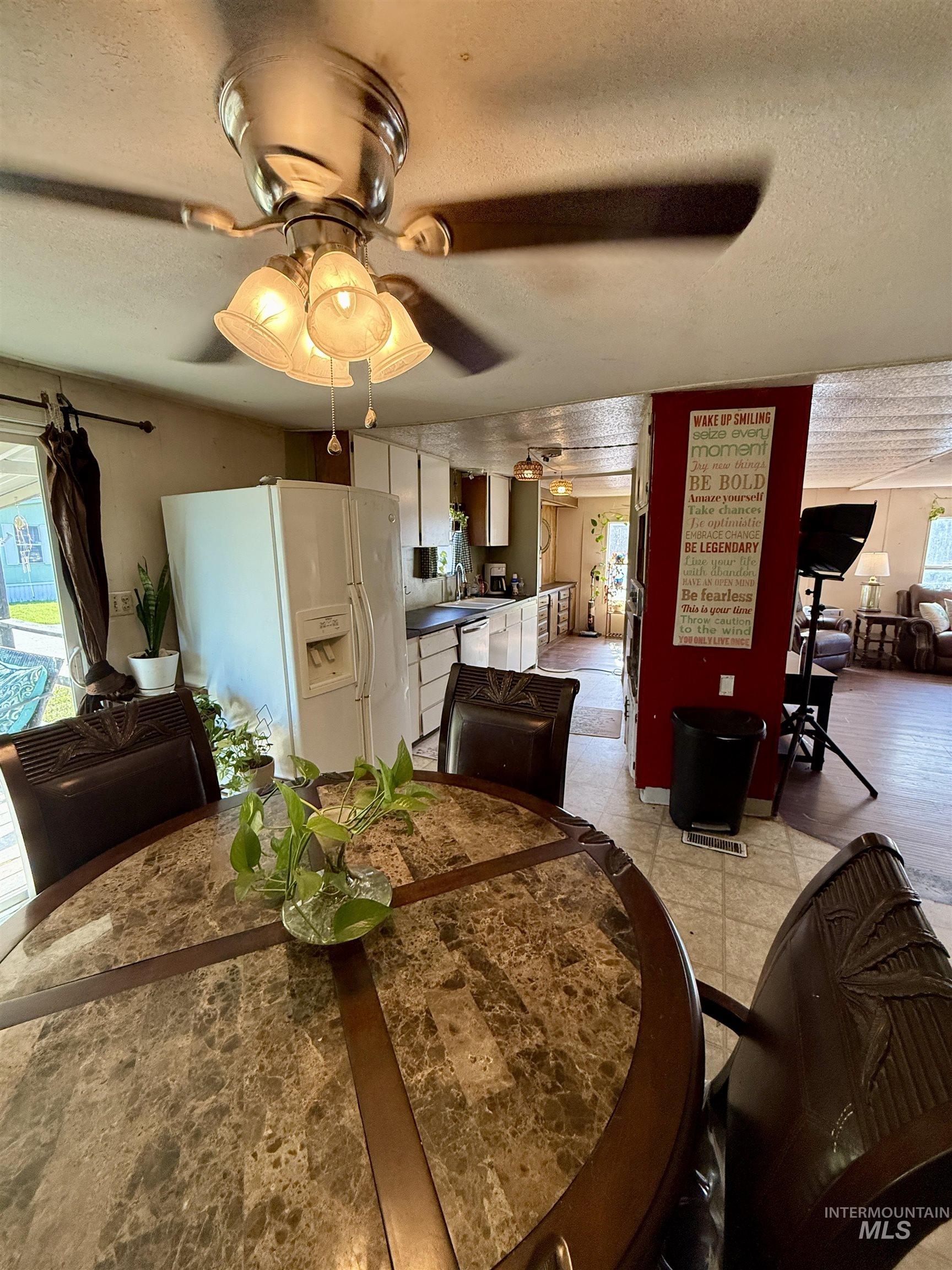 Dining room with a textured ceiling and ceiling fan