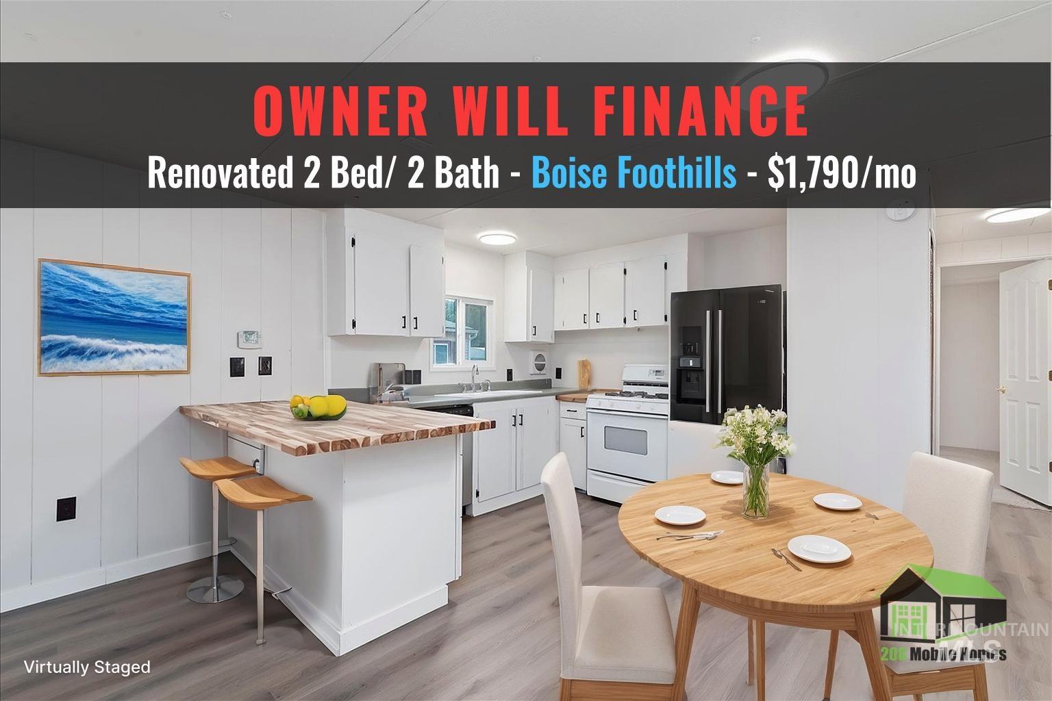 Kitchen featuring a kitchen bar, black fridge, white cabinetry, gas range gas stove, and butcher block counters