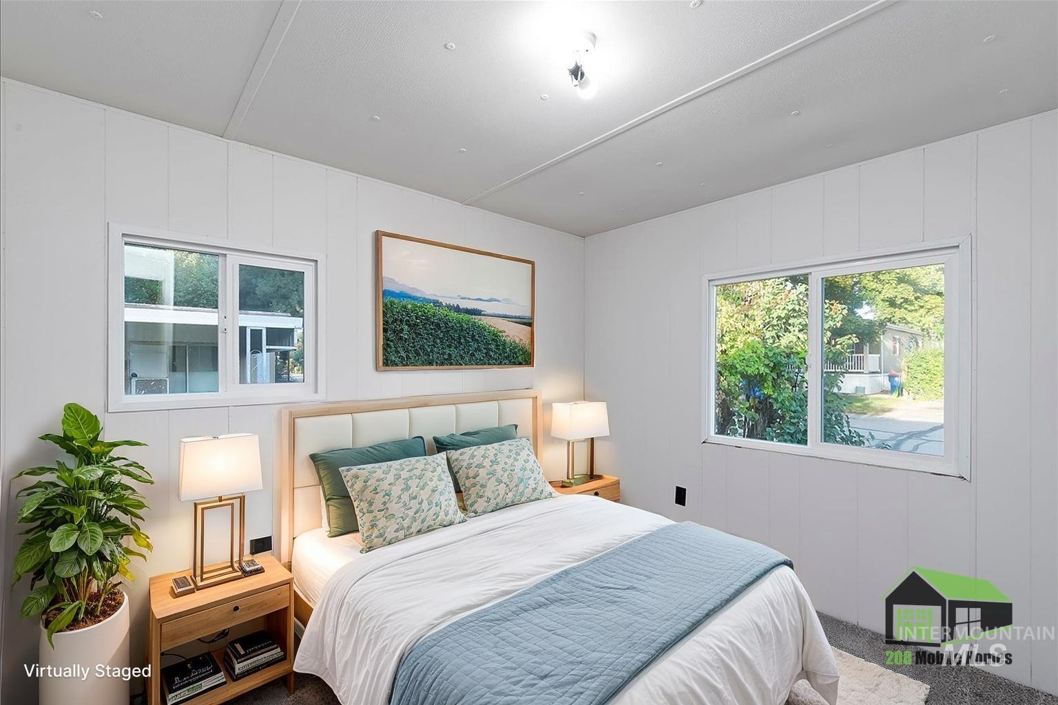 Carpeted bedroom with multiple windows and wooden walls