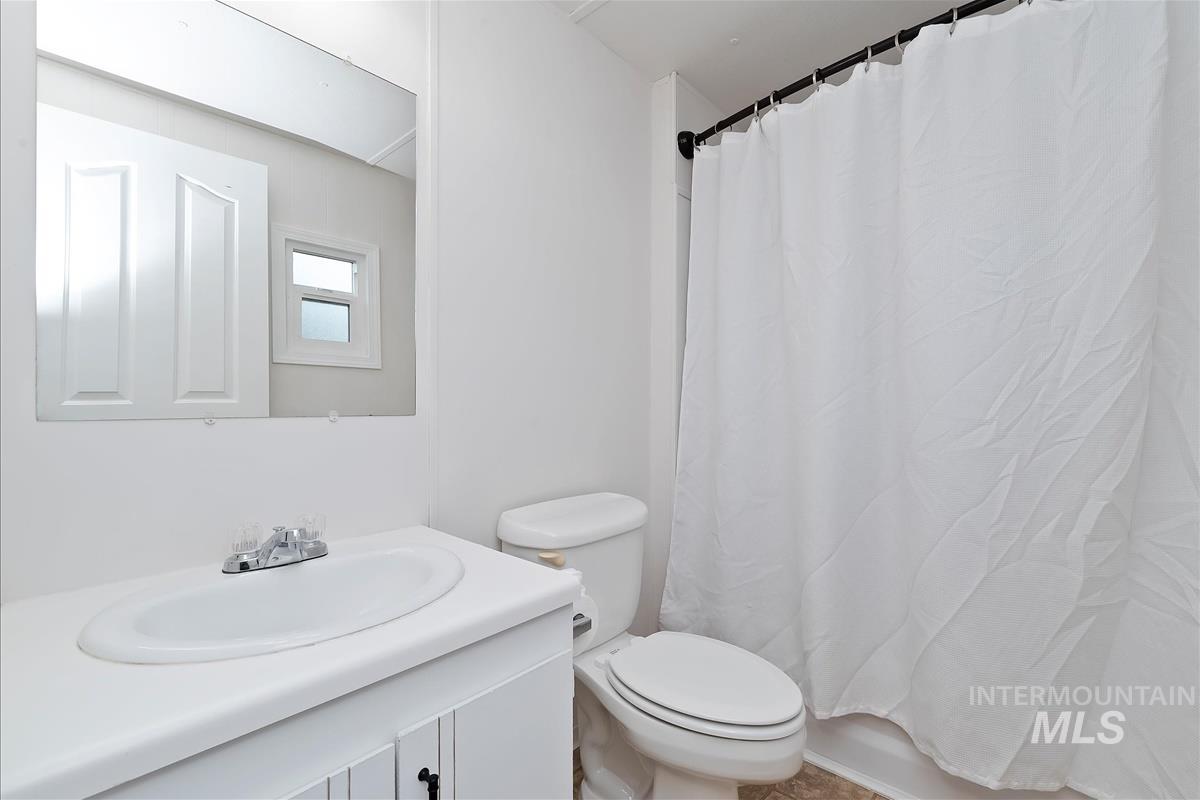 Full bathroom featuring vanity and shower / tub combo with curtain
