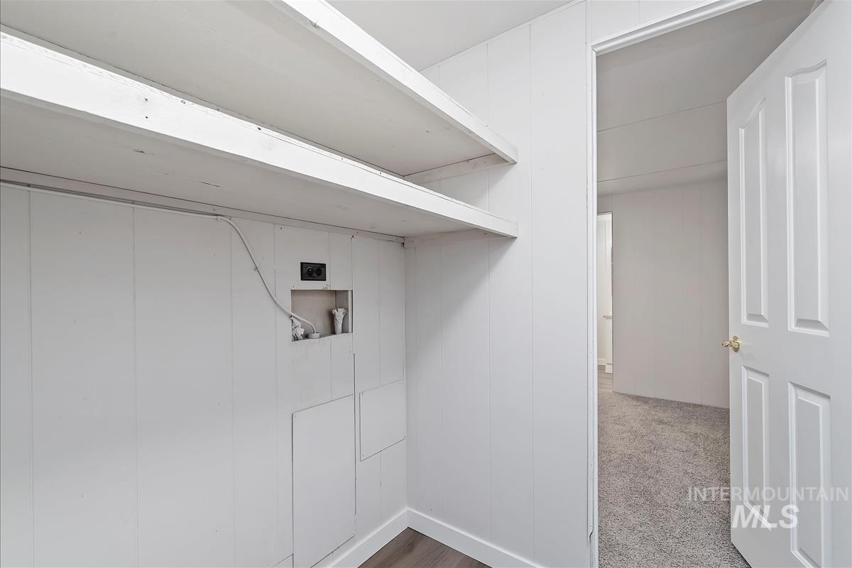 Laundry room with light carpet