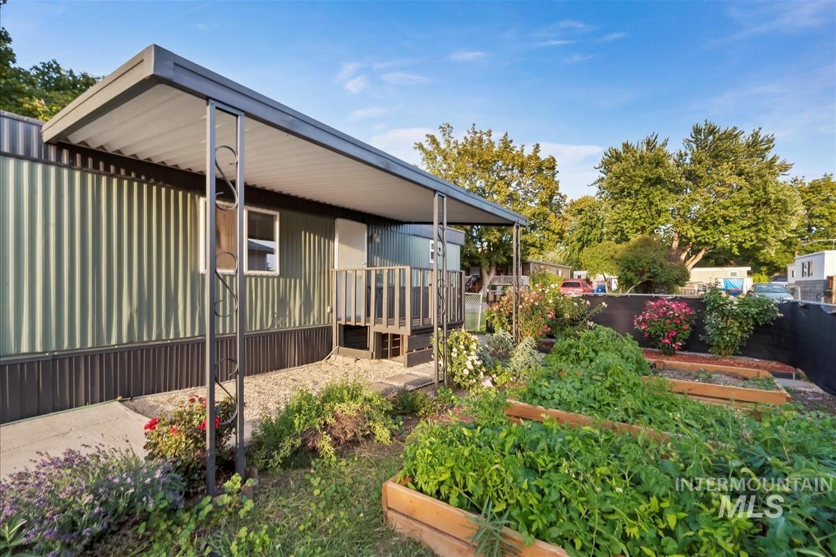 View of side of home with a garden