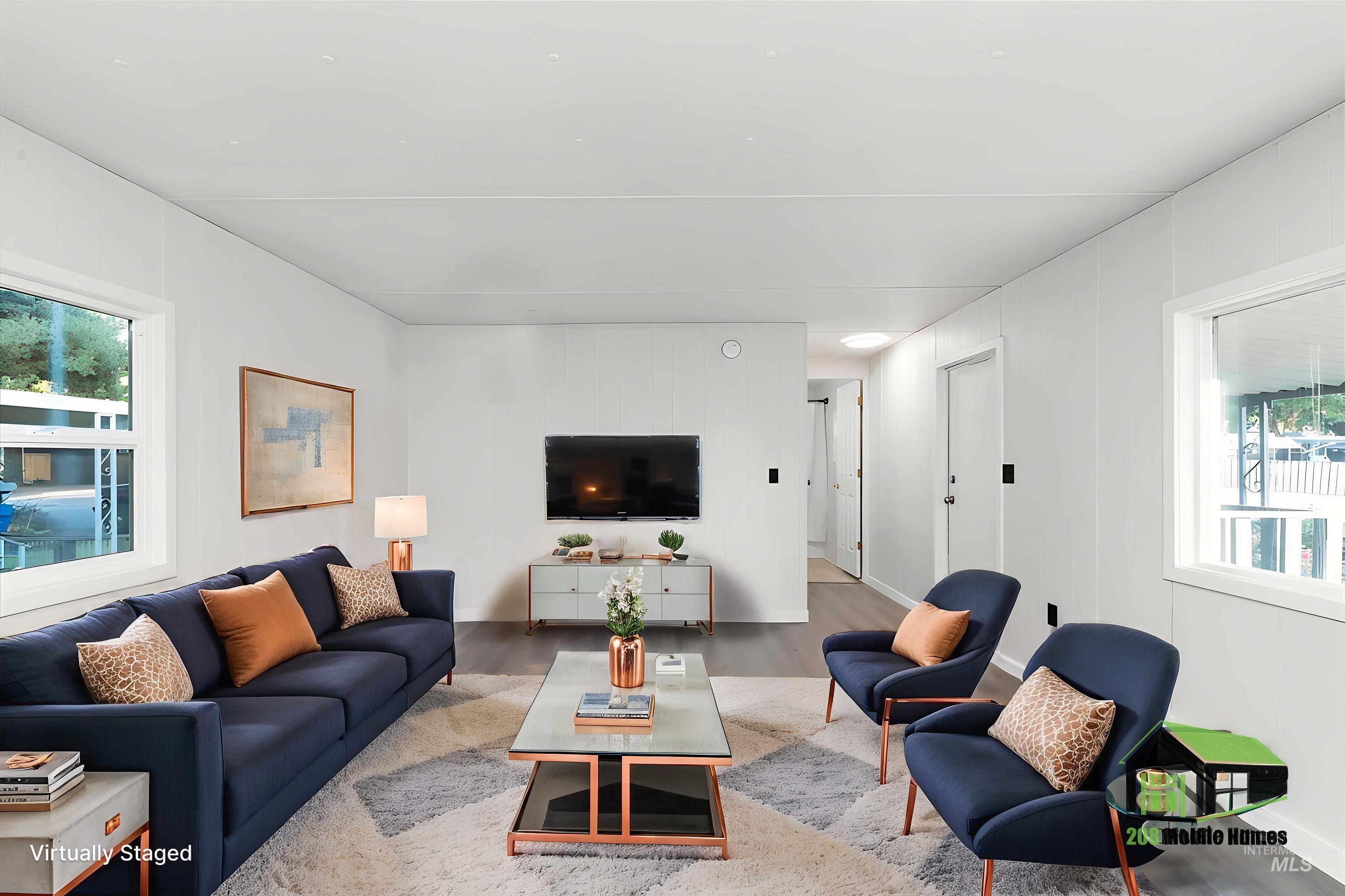 Living room with plenty of natural light and wood finished floors
