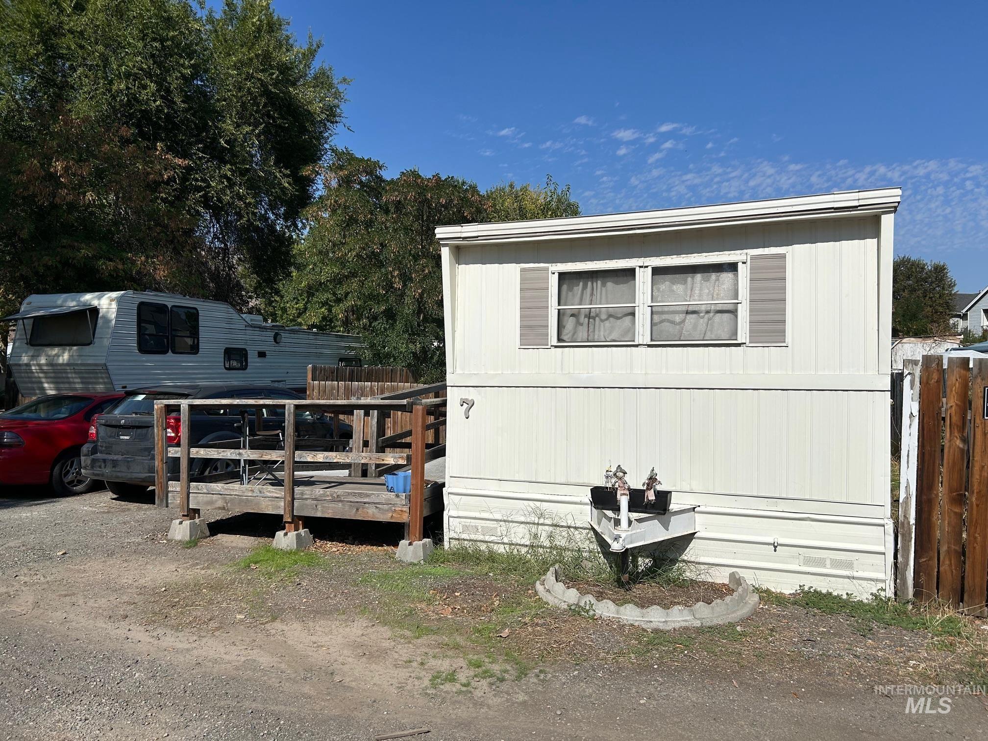 View of property exterior with a wooden deck