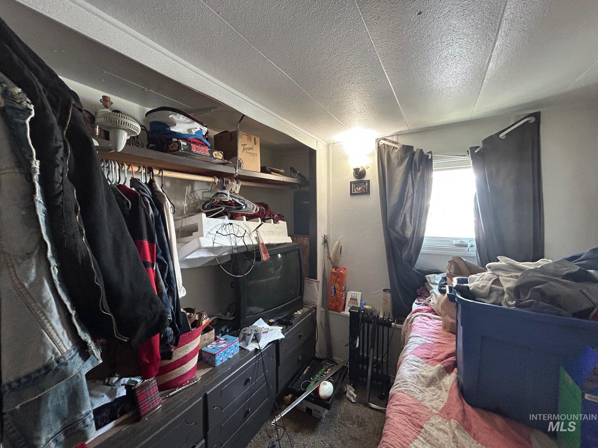 Carpeted bedroom featuring a textured ceiling