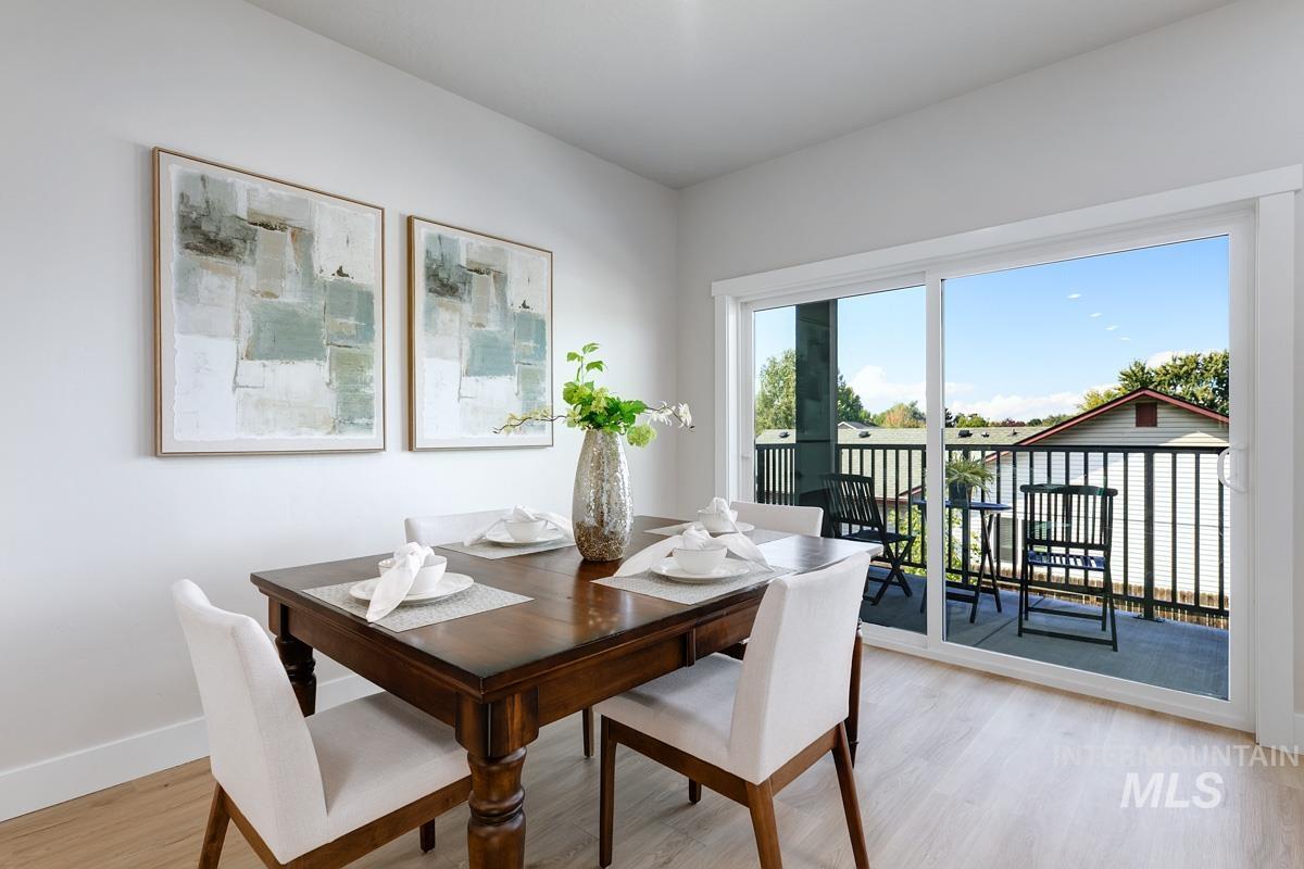 Dining area with light wood finished floors and baseboards
