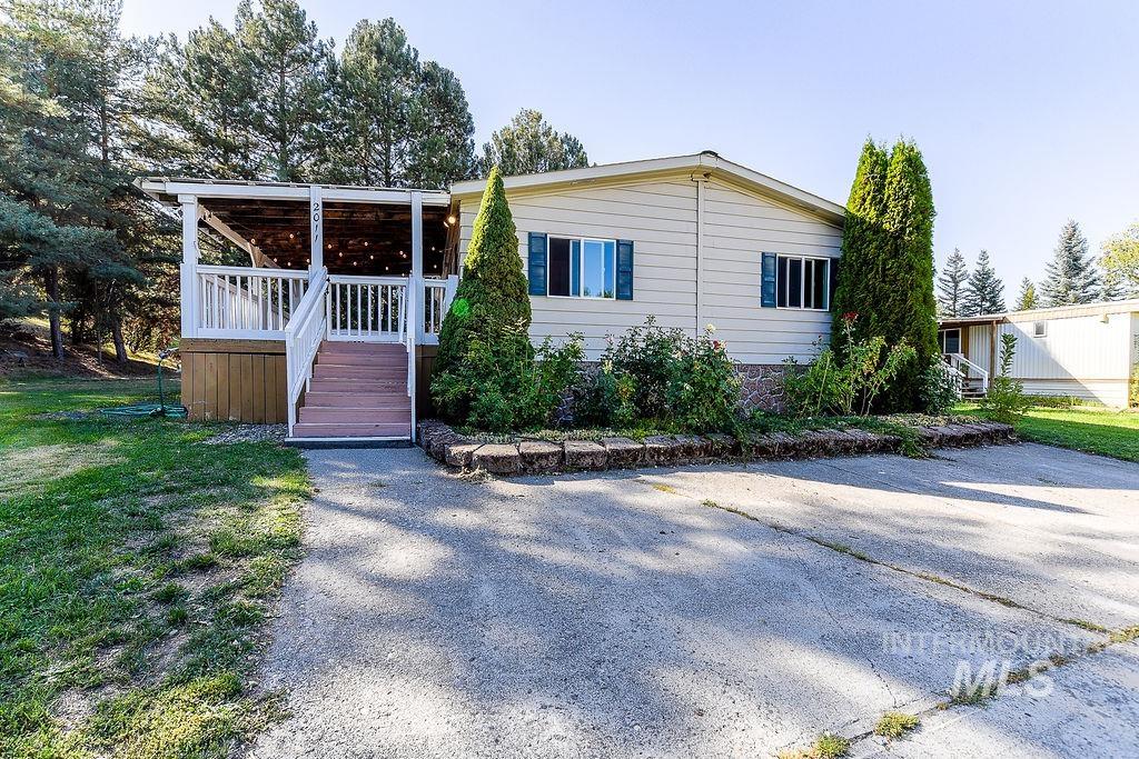 Manufactured / mobile home with stairway and a wooden deck