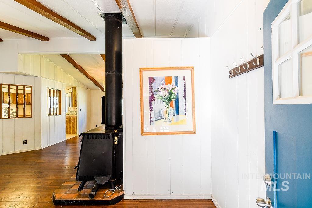 Hall with dark wood-style floors and wood walls