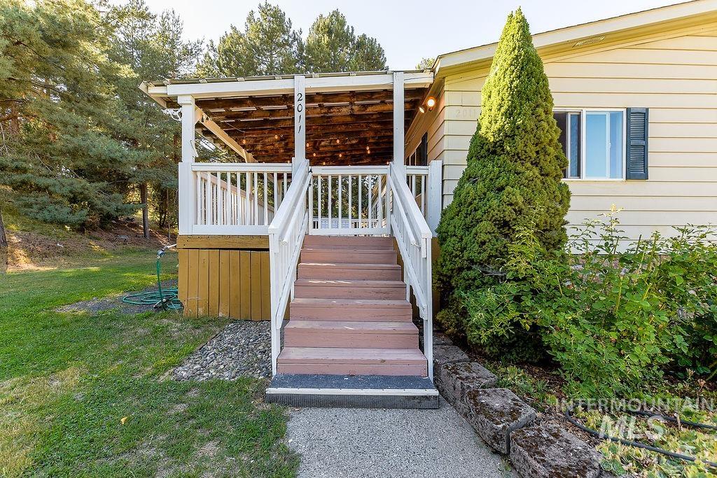 Wooden deck with stairway and a lawn