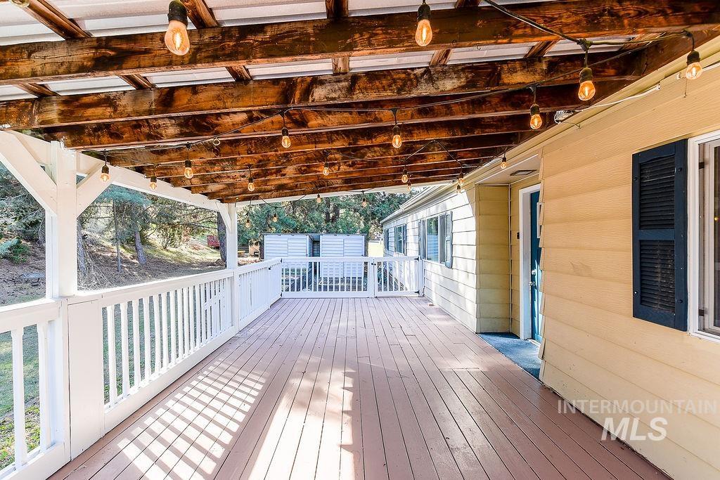 Wooden terrace featuring a shed